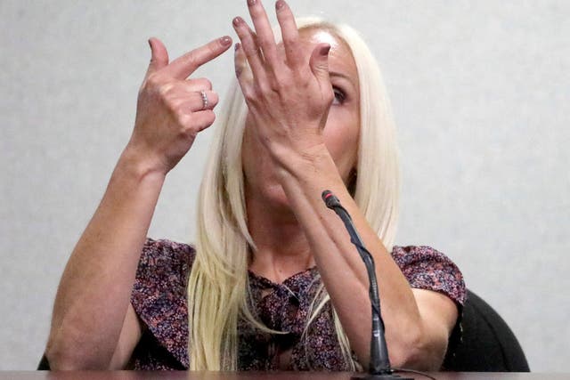 <p>Nicole Oulson describes the moment she was shot in the hand at a Wesley Chapel movie theater in  2014 during the second-degree murder trial for former Tampa Police Captain Curtis Reeves on Monday, Feb. 14, 2022, at the Robert D. Sumner Judicial Center in Dade City, Fla. Reeves stands accused of shooting and killing Oulson's husband, Chad Oulson, and inuring Oulson. (Douglas R. Clifford/Tampa Bay Times via AP)</p>