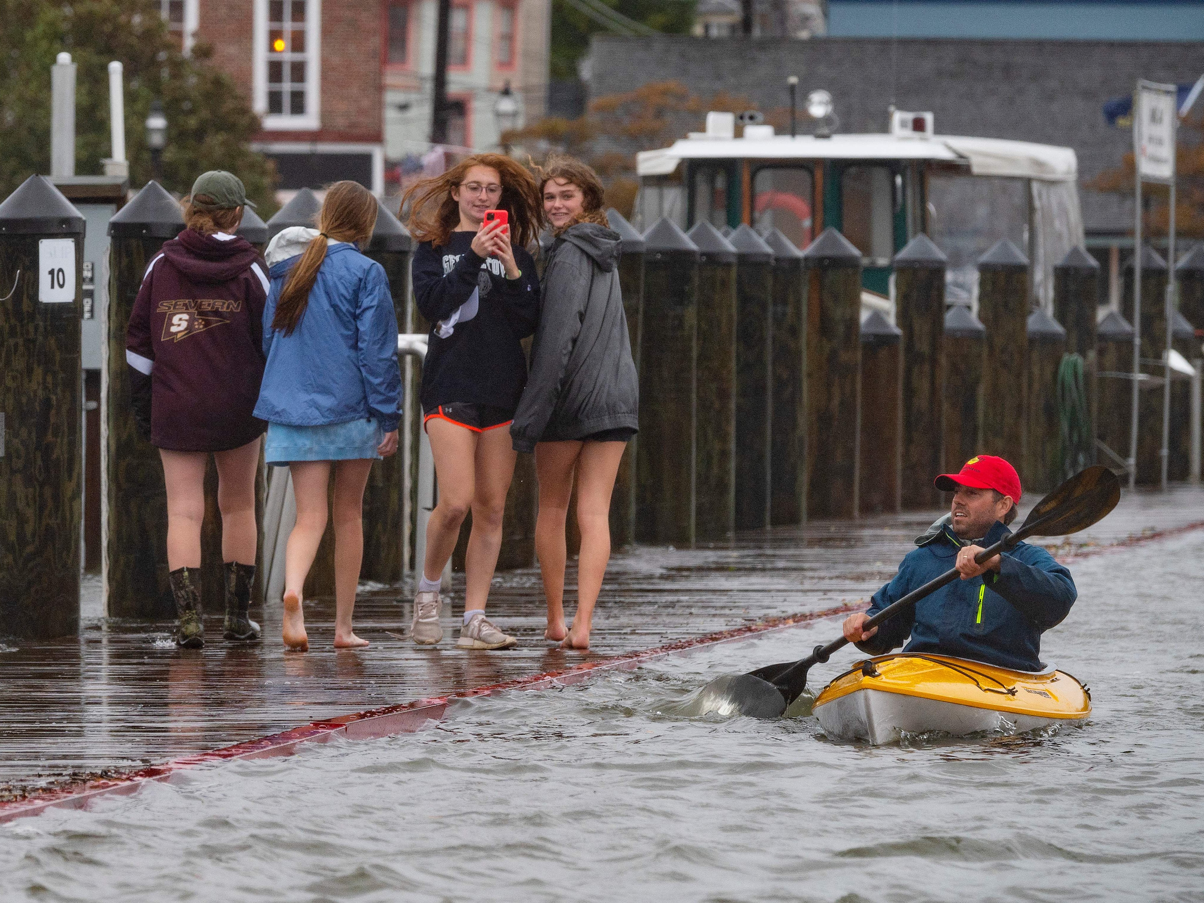 Locals navigate a flooded street in downtown Annapolis, Maryland, in October 2021
