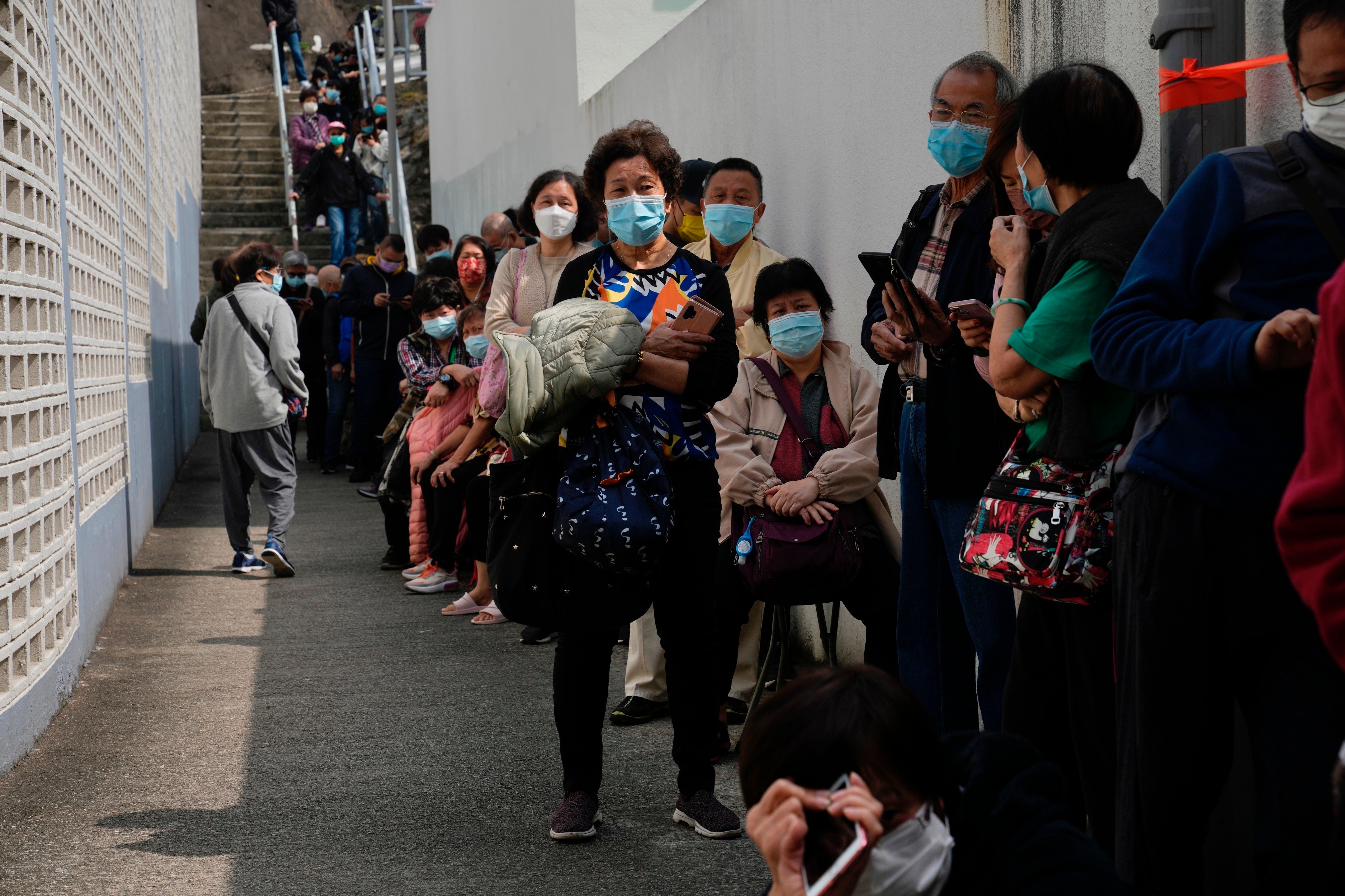 Residents line up to get tested for the coronavirus at a temporary testing center for Covid, in Hong Kong, 15 February 2022
