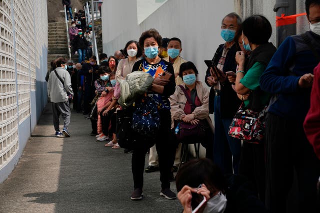 <p>Residents line up to get tested for the coronavirus at a temporary testing center for COVID-19, in Hong Kong on Tuesday </p>
