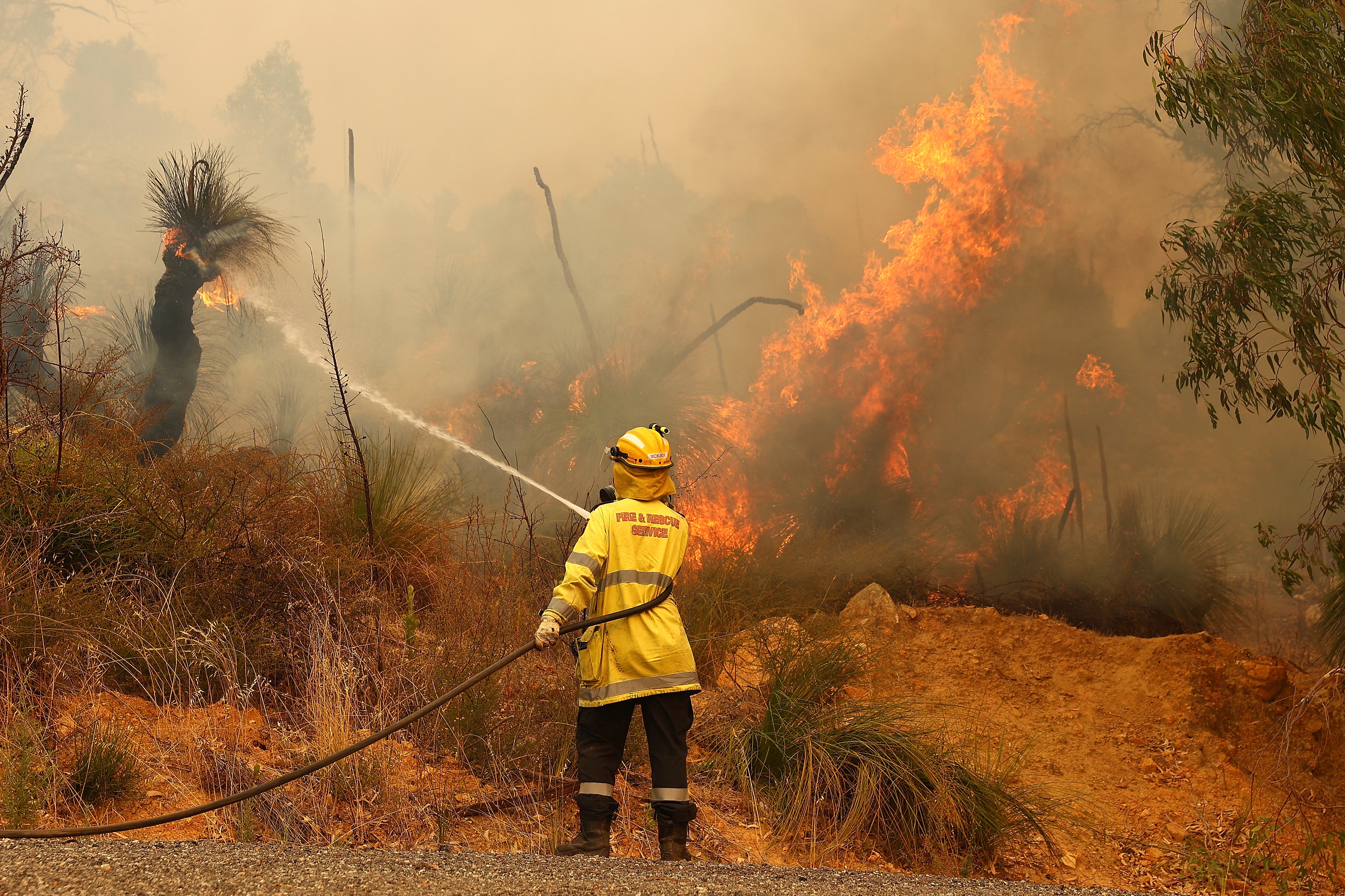 Fire crews control bush fires as they approach properties on Copley Road in Upper Swan on 2 February, 2021 in Perth, Australia