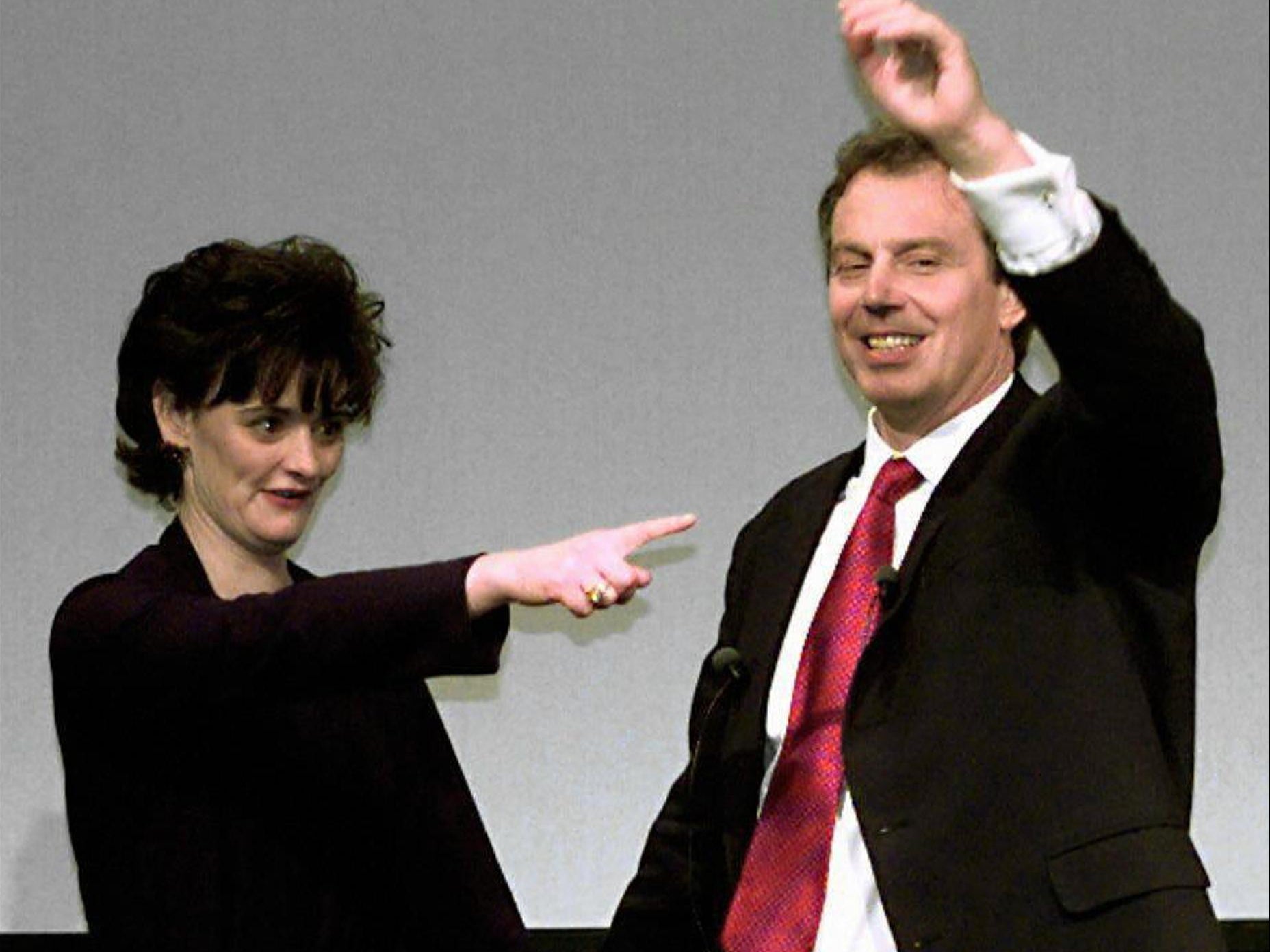 Blair and his wife Cherie waving to party workers and supporters upon arrival at a Labour Party meeting