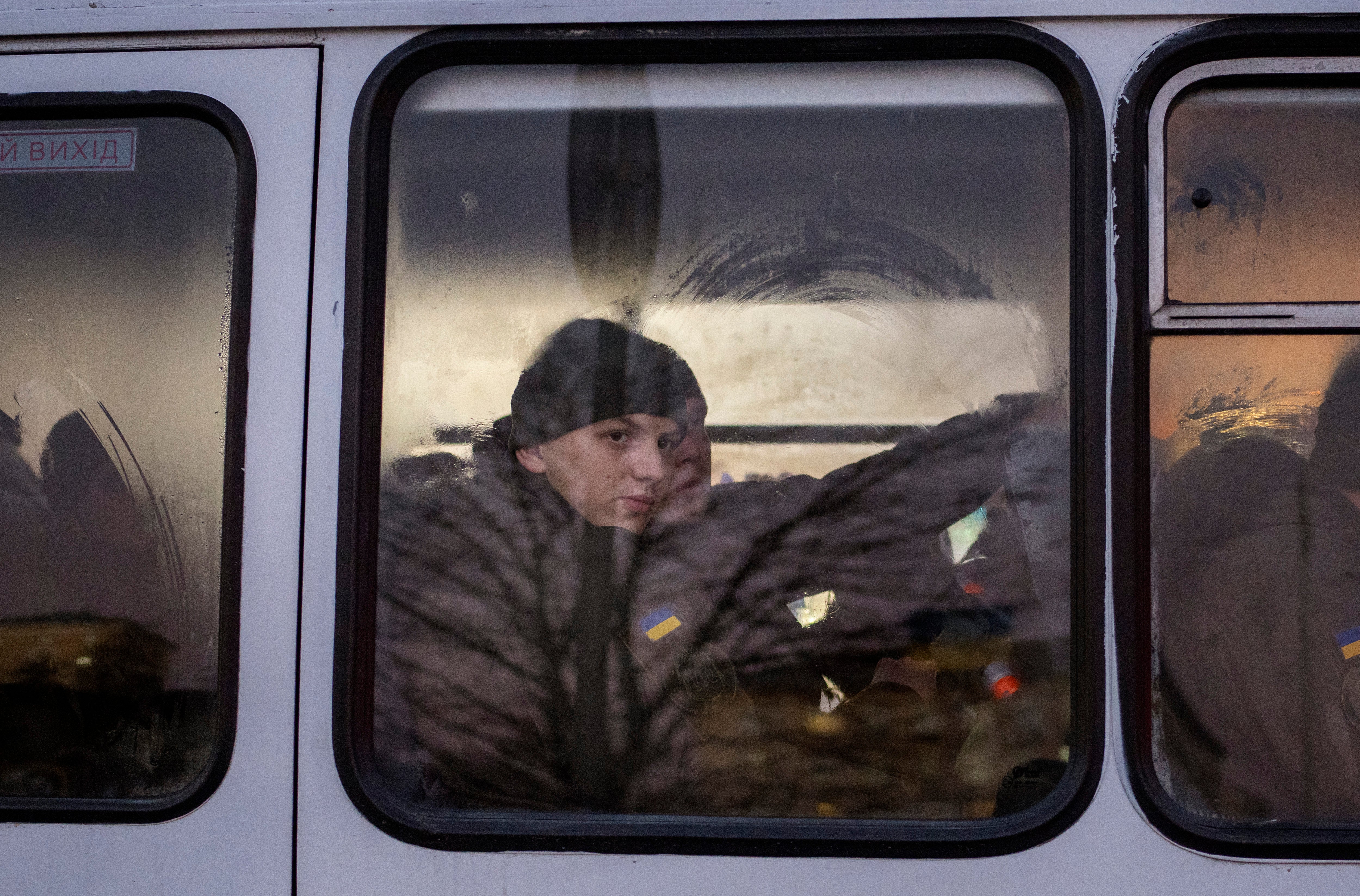 Members of National Guard of Ukraine look out of the window as they ride in a bus through the city of Kyiv (Emilio Morenatti/AP/Press Association Images)