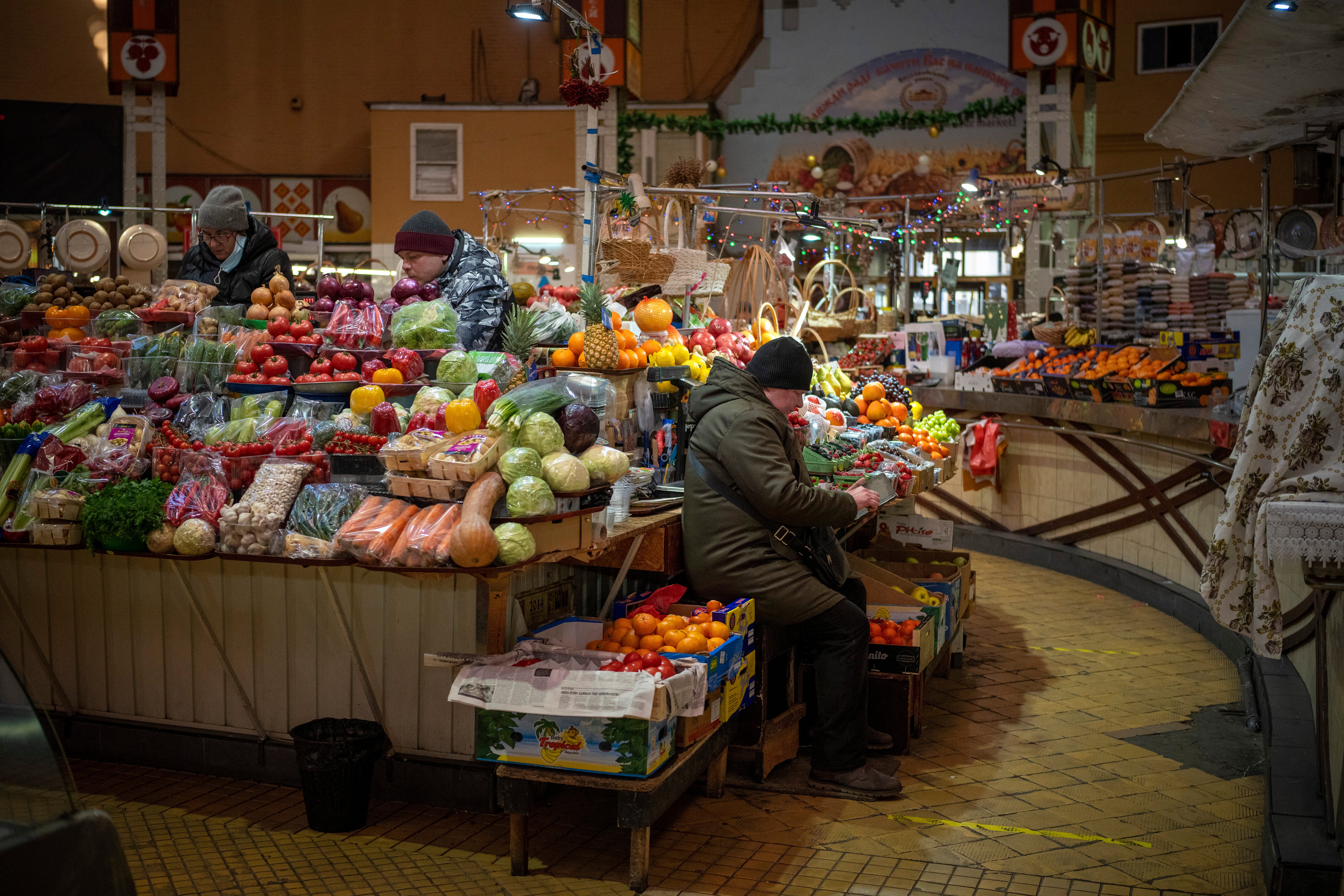 Vendors wait for customers at their fruit market stall in Kyiv, Ukraine (Emilio Morenatti/AP/Press Association Images)