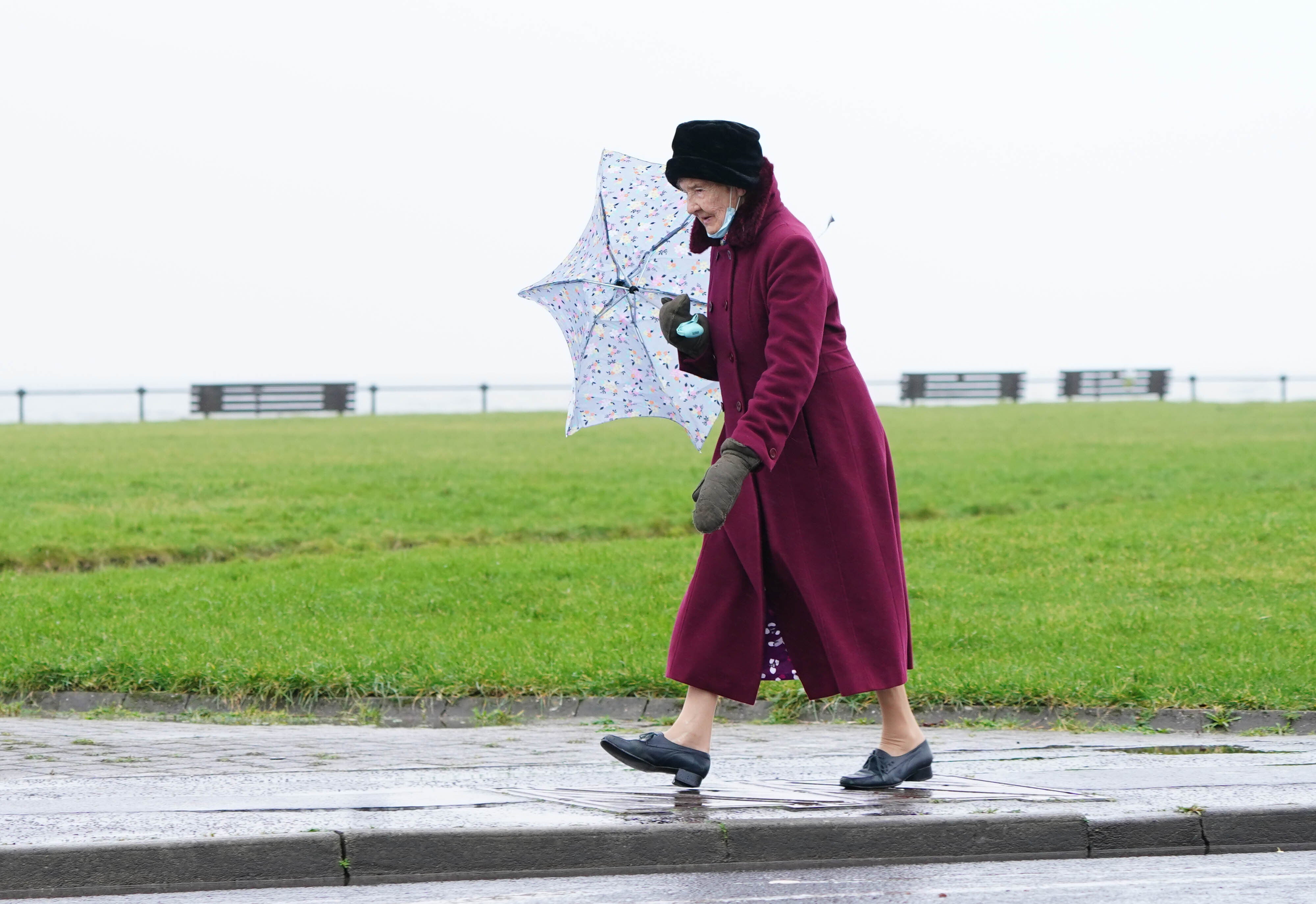 A woman walks along the sea front in Ardrossan in North Ayrshire before Storm Dudley hits (Jane Barlow/PA)