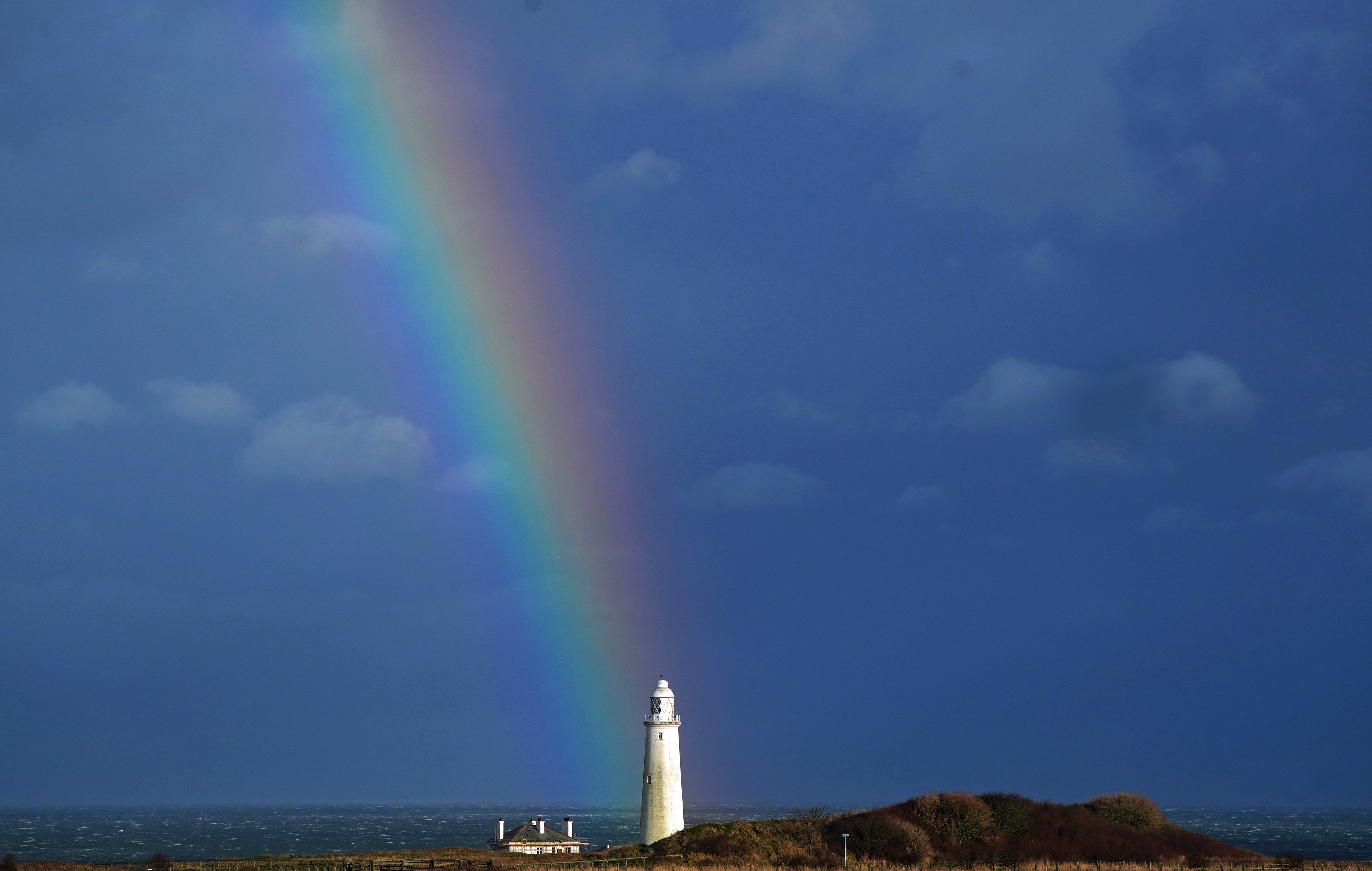 A rainbow over St Mary’s Lighthouse in Whitley Bay, Tyne and Wear, ahead of Storm Dudley (Owen Humphreys/PA)