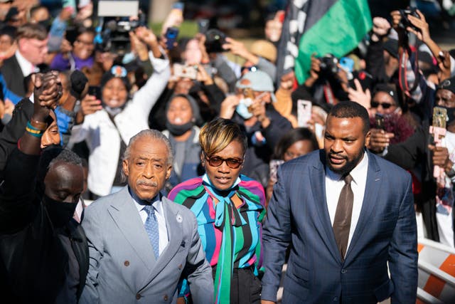 <p>Lee Merritt with Ahmaud Arbery’s mother Wanda Cooper-Jones and Rev. Al Sharpton (from right to left) outside the courthouse in Georgia after the Black jogger’s three killers were found guilty of murder</p>