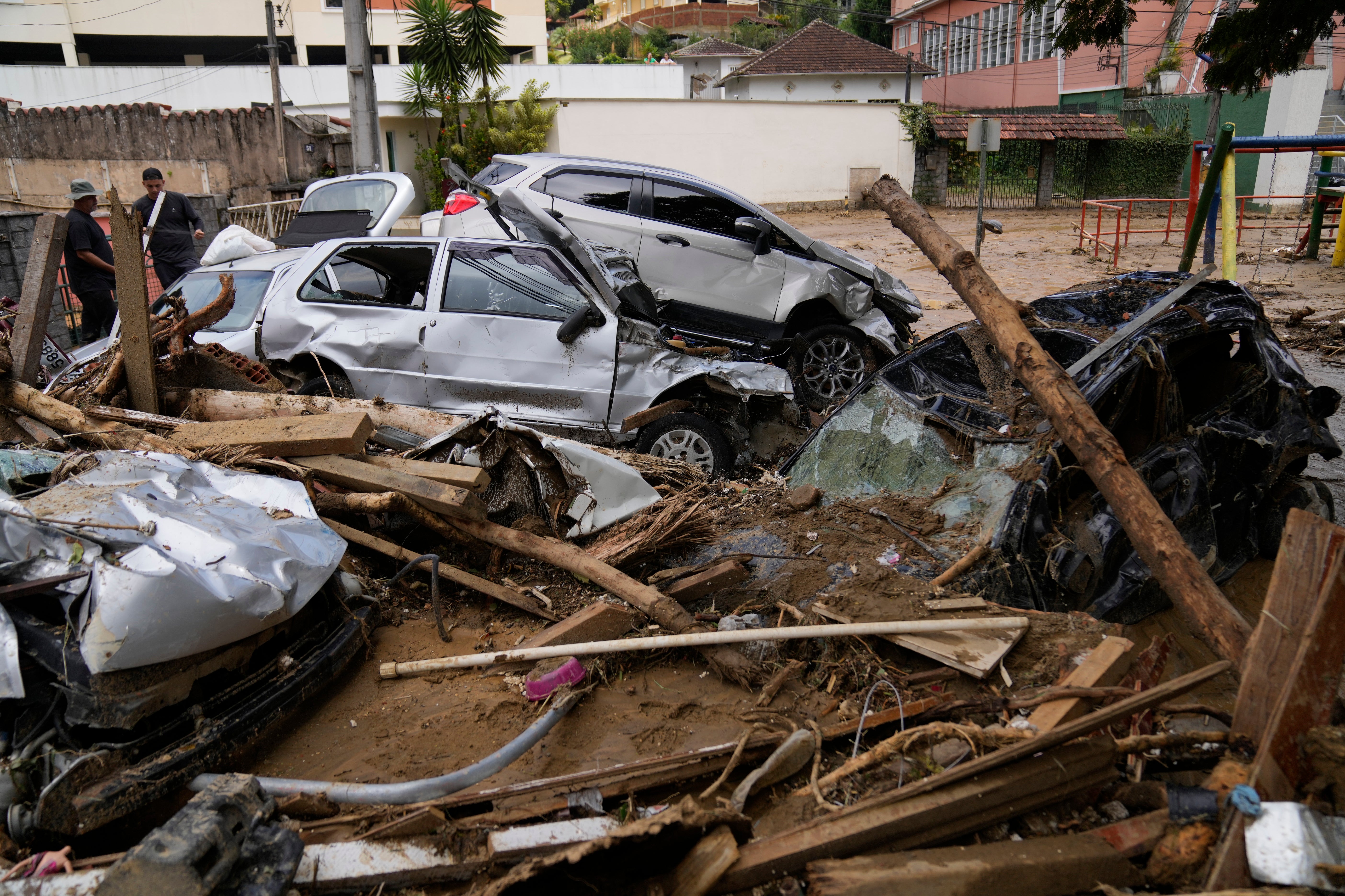 Crumpled cars sit atop wreckage caused by a mudslide, in Petropolis, Brazil on Wednesday