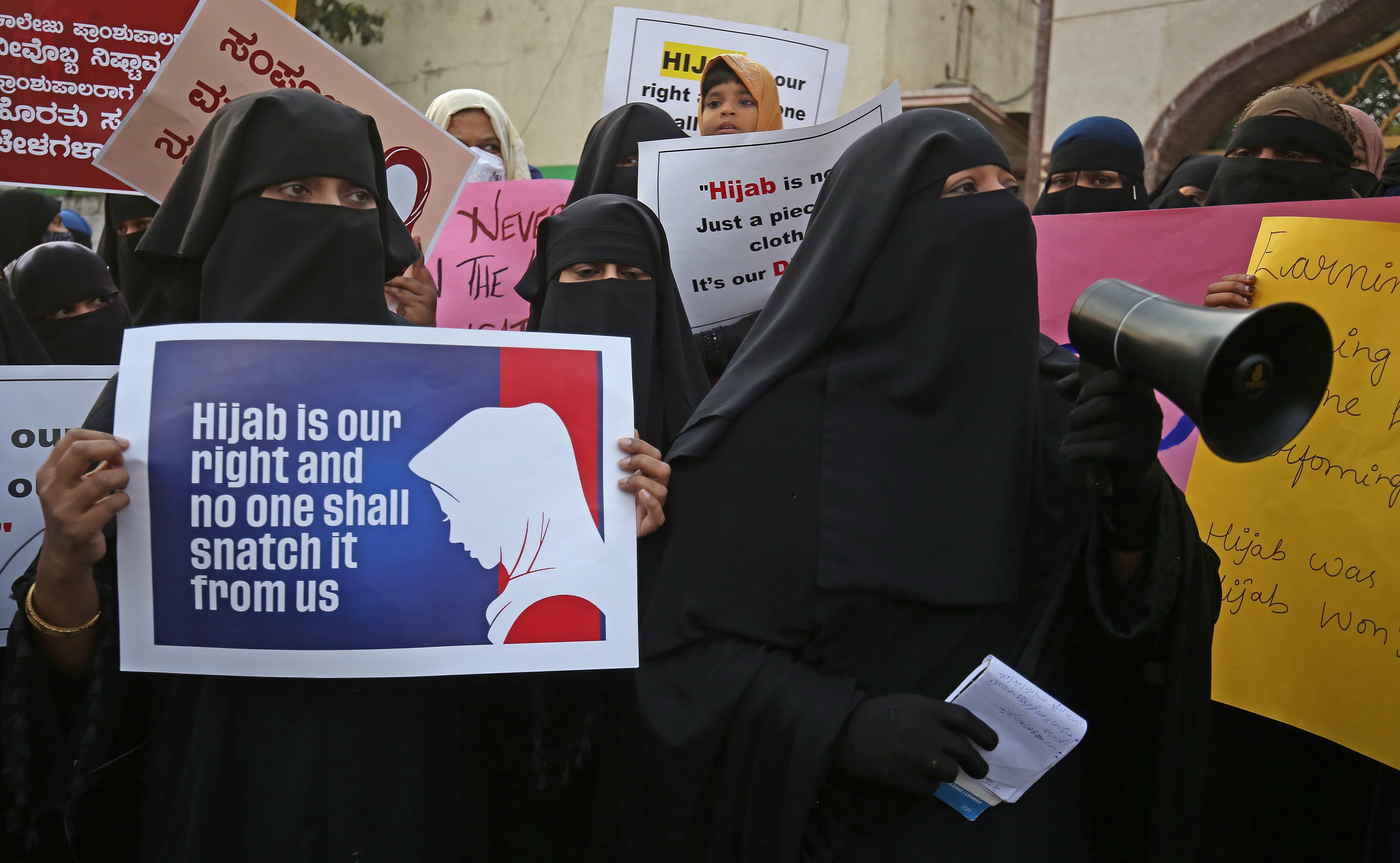 Members from different organization and Muslim women wearing Hijab attend a protest in Bangalore