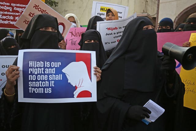<p>Members from different organization and Muslim women wearing Hijab attend a protest in Bangalore</p>