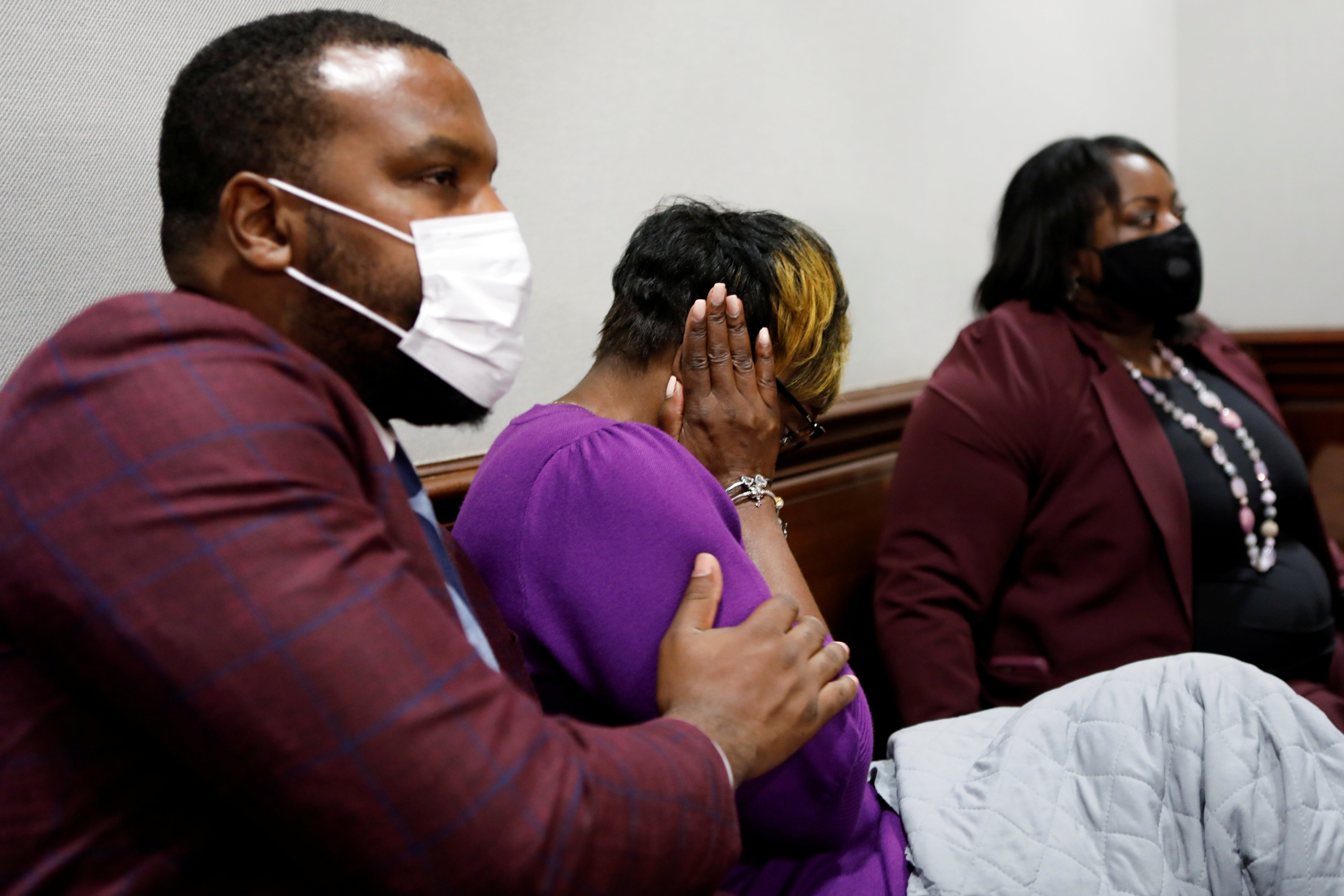Lee Merritt comforts Wanda Cooper-Jones, mother of Ahmaud Arbery, as she reacts while seeing photos of her son shown at his killers’ state trial