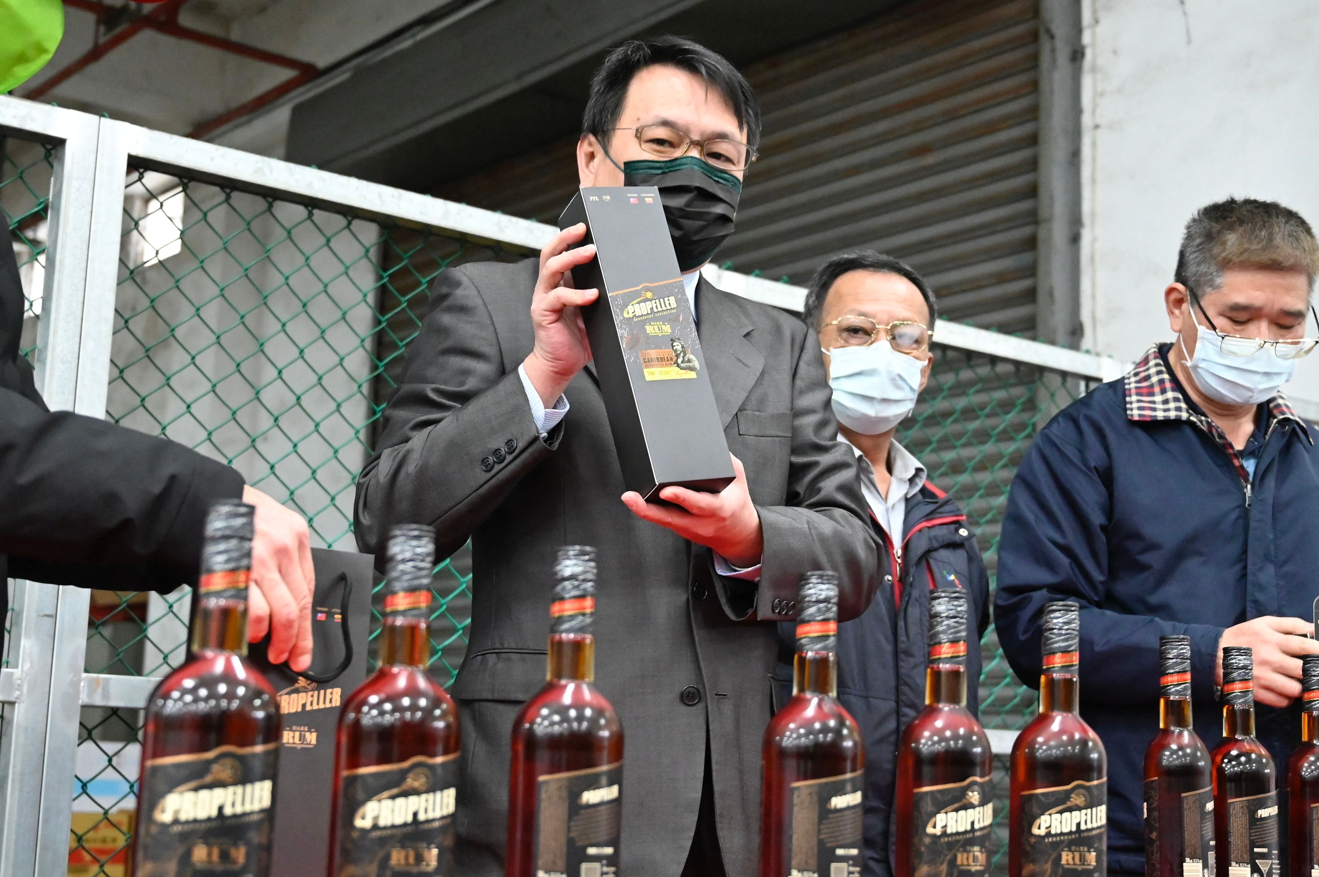 Ting Yen-che, Chairman of Taiwan Tobacco and Liquor Corp, poses with bottles of Lithuanian rum