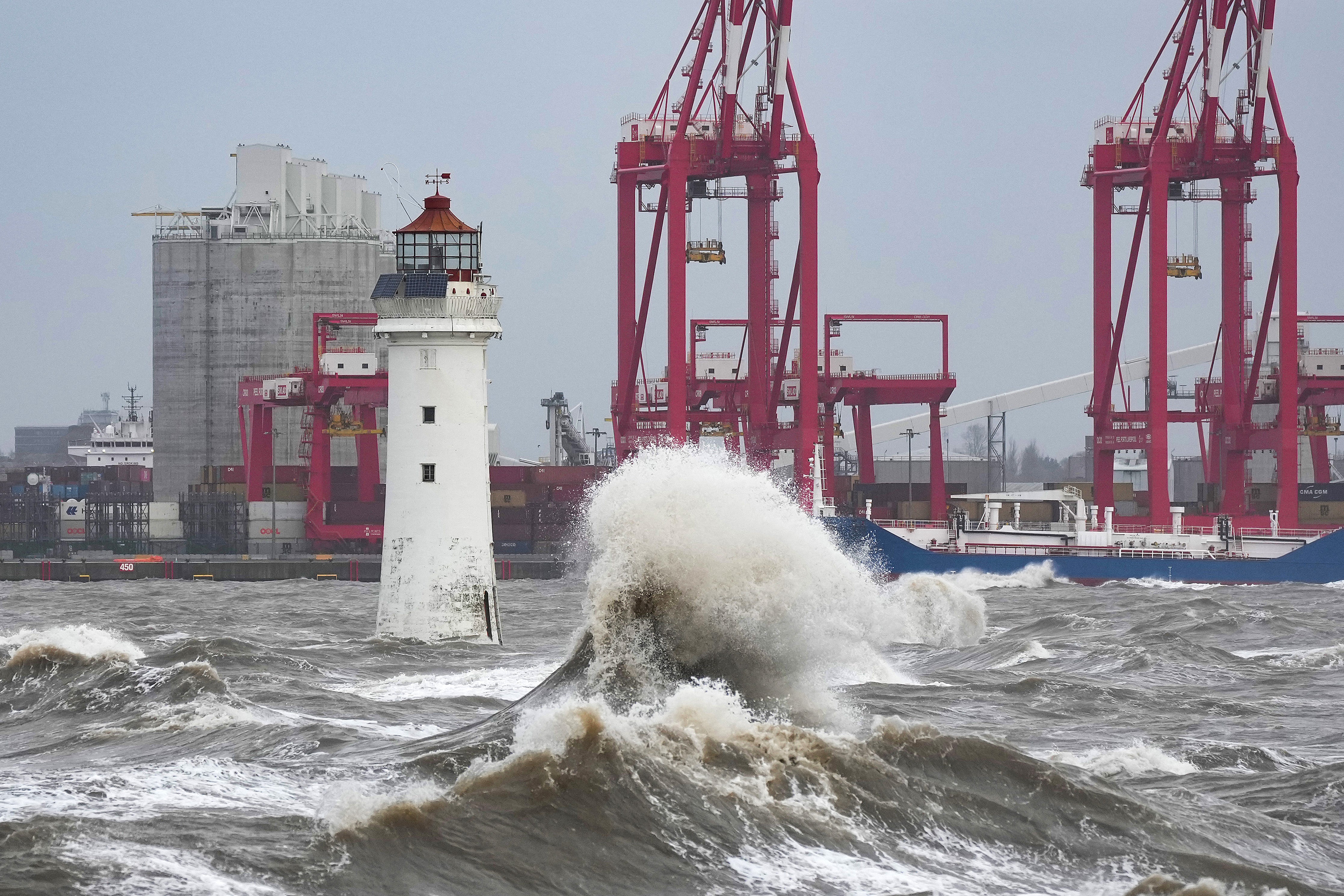 Waves created by high winds and Spring tides hit the sea wall at New Brighton promenade