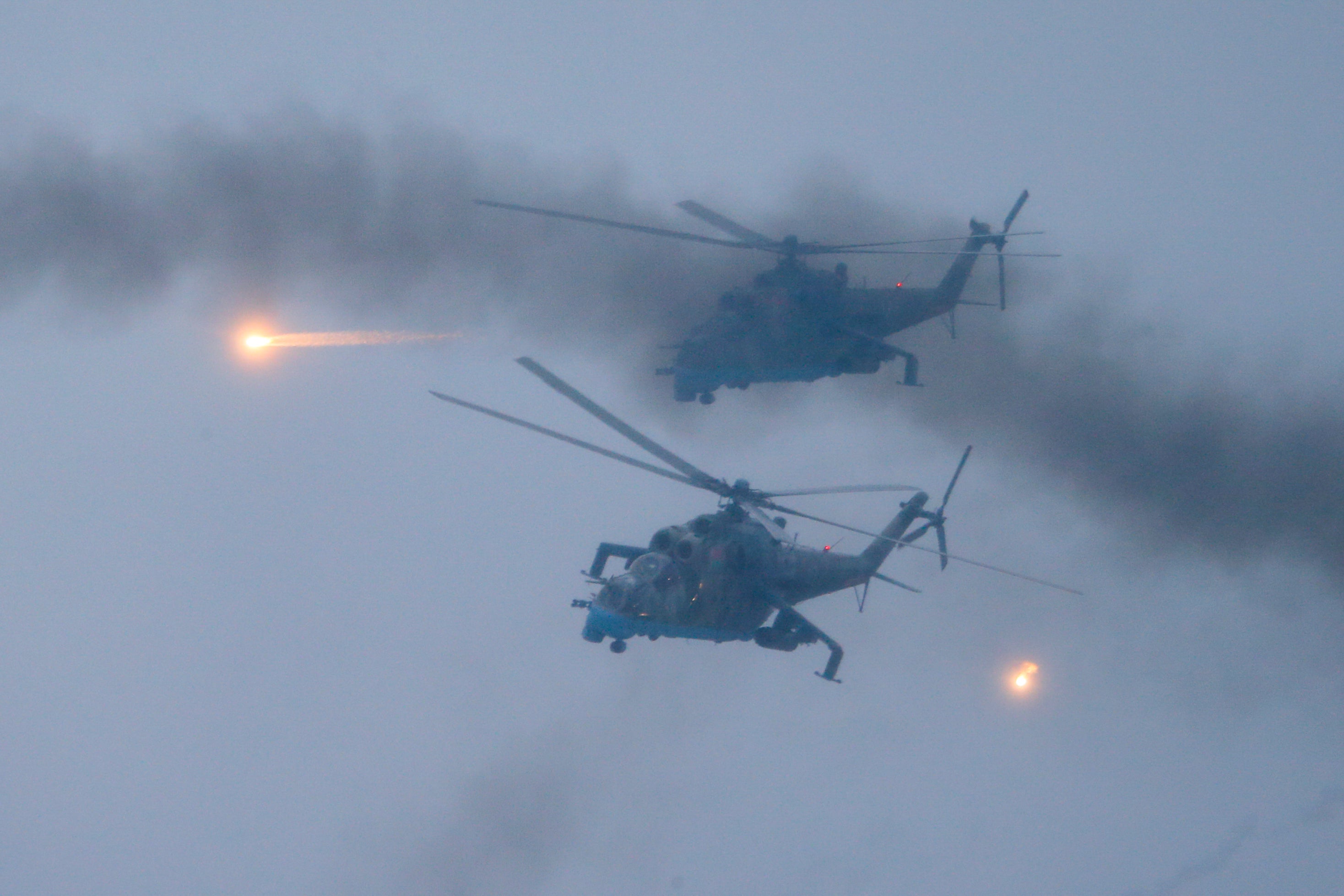 Military helicopters fly over the Osipovichi training ground during the Union Courage-2022 Russia-Belarus military drills near Osipovichi , Belarus