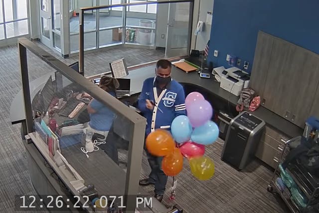 <p>Oglethorpe Avenue Elementary School Principal Bipul Singh pops a cluster of balloons supporting a student whose LGBT-themed artwork was removed by the school.  </p>