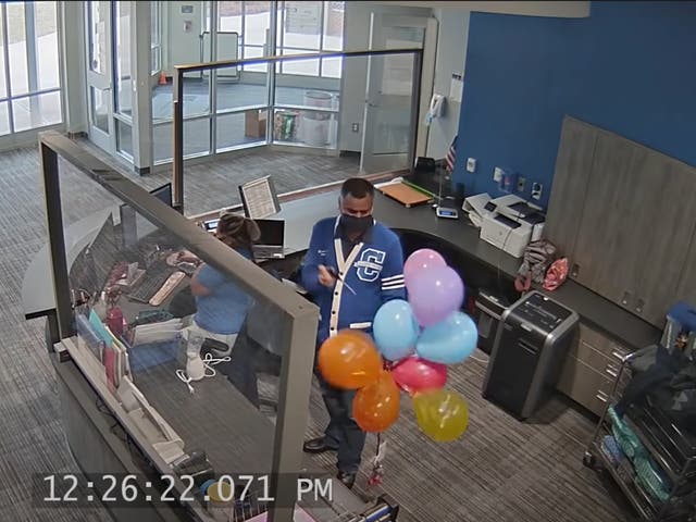 <p>Oglethorpe Avenue Elementary School Principal Bipul Singh pops a cluster of balloons supporting a student whose LGBT-themed artwork was removed by the school.  </p>