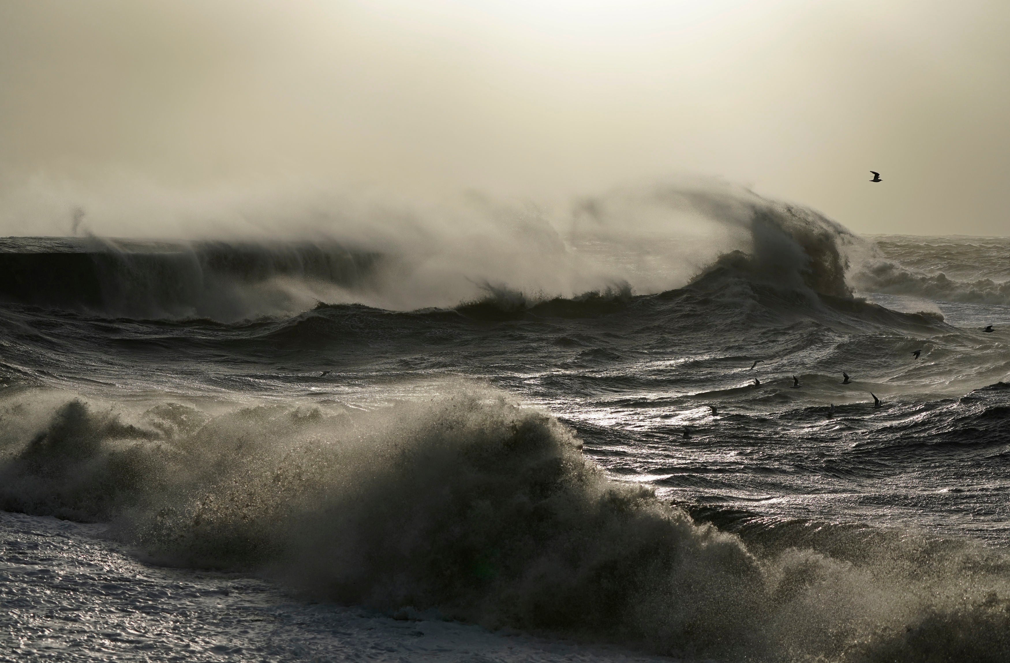 Waves crash against the Cobb in Lyme Regis, Dorset