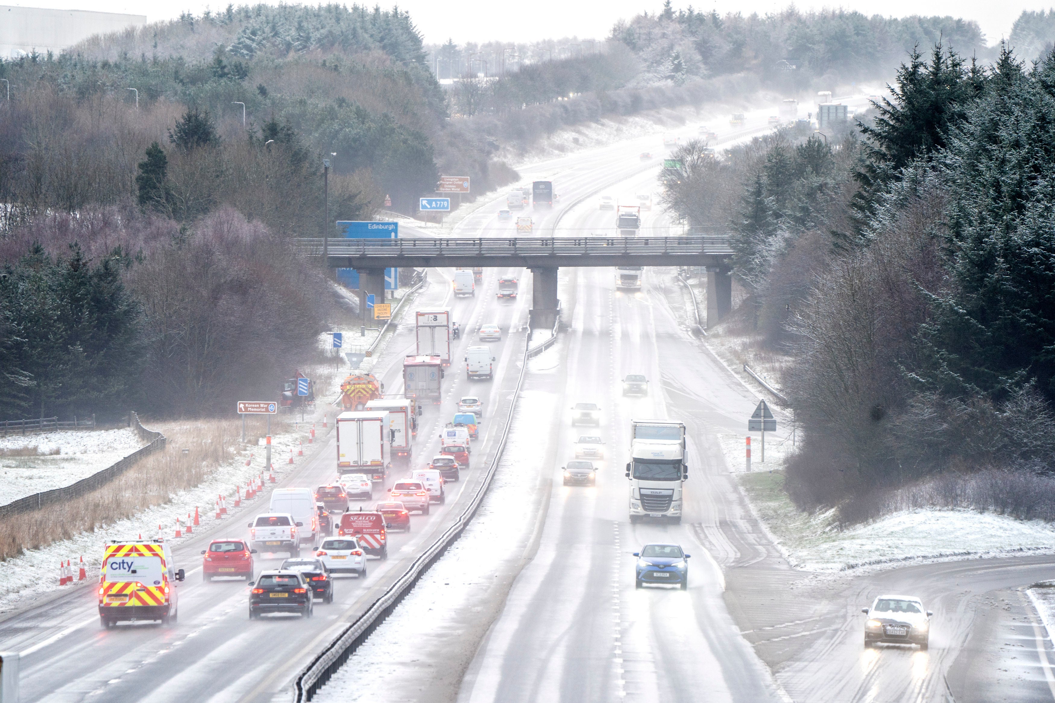 Motorists drive through the sleet and snow along the M8 motorway near Bathgate in West Lothian