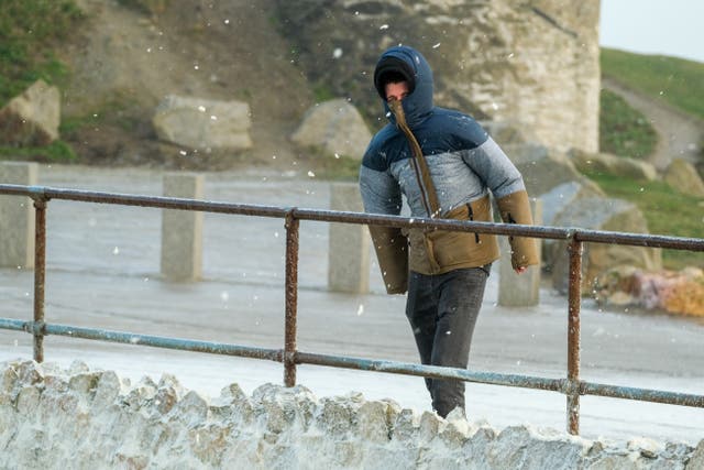 <p>A man walks in high winds along the seafront in Newquay on the Cornish coast as Storm Eunice makes landfall </p>