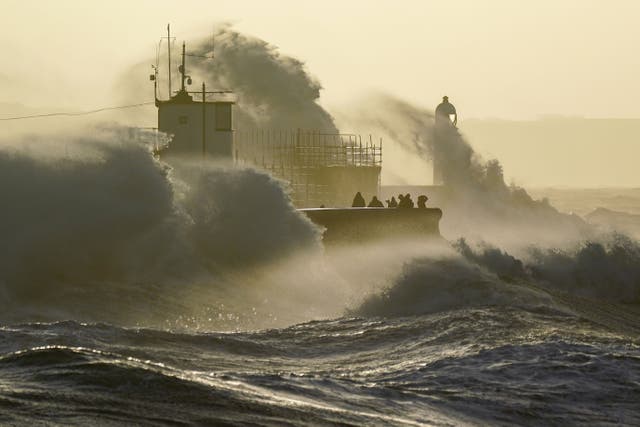 Waves crash against the sea wall and Porthcawl Lighthouse in Porthcawl, Bridgend, Wales, as Storm Eunice hits the south coast, with attractions closing, travel disruption and a major incident declared in some areas, meaning people are warned to stay indoors. Picture date: Friday February 18, 2022.