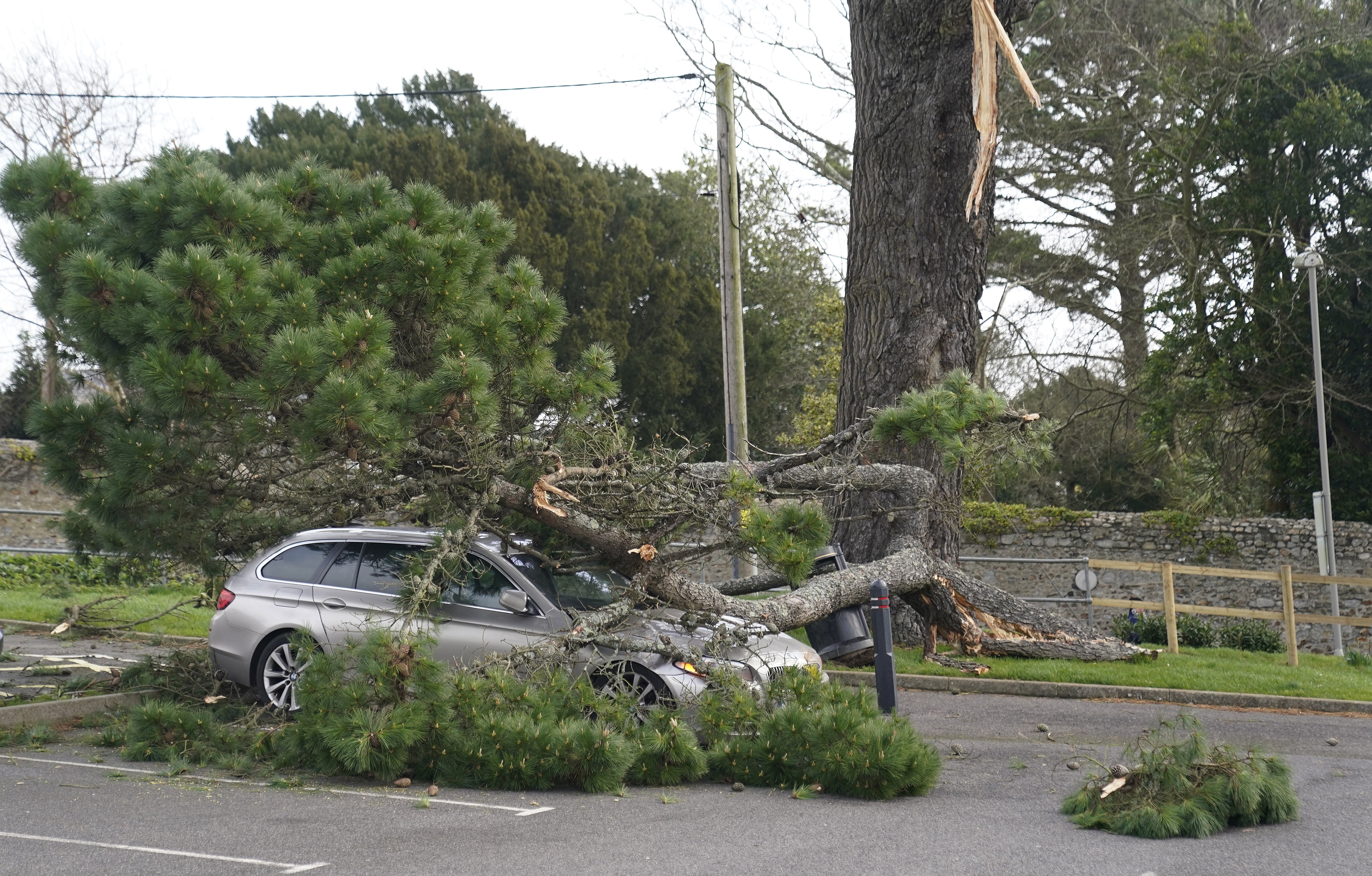A fallen branch on a car in a car park in Lyme Regis, west Dorset (Andrew Matthews/PA)