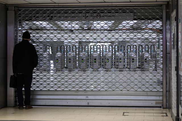 <p>A man looks at a closed entrance at the Gare du Nord metro station in Paris, France, 18 February 2022 </p>