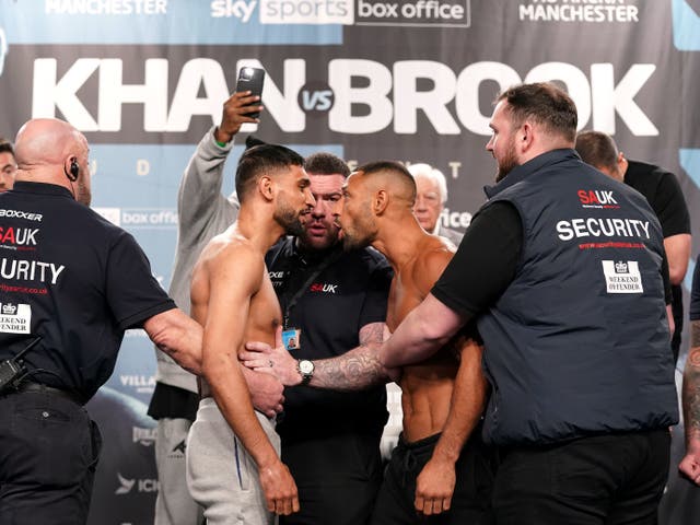 <p>Amir Khan (left) and Kell Brook face off after making weight for their grudge match</p>