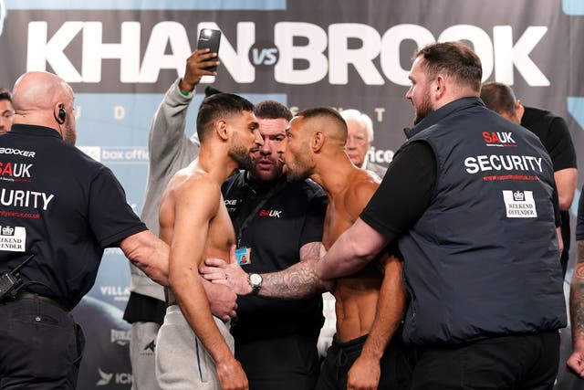 <p>Amir Khan (left) and Kell Brook face off after making weight for their grudge match</p>