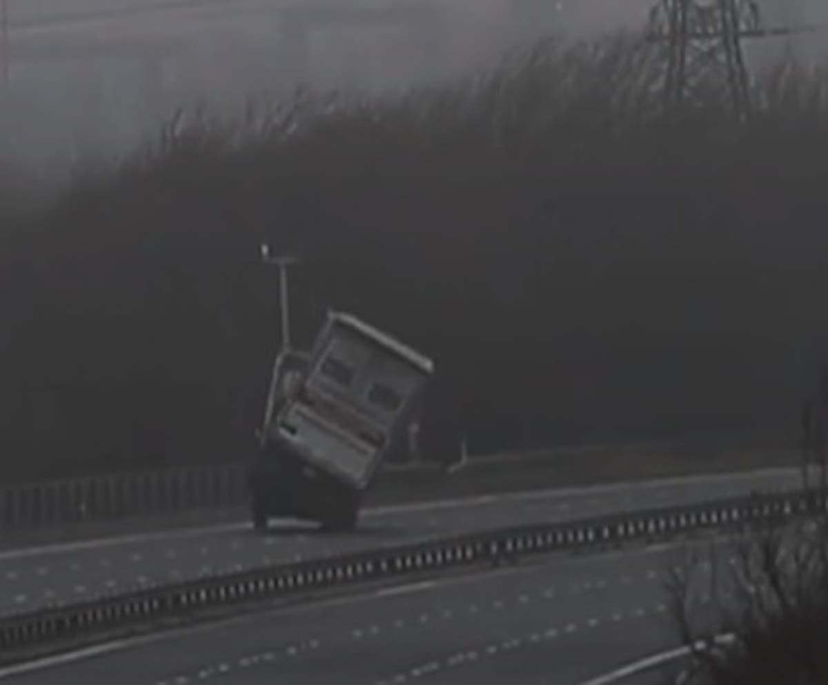 Storm Eunice: Huge lorry topples on motorway in dramatic footage of 100mph storms