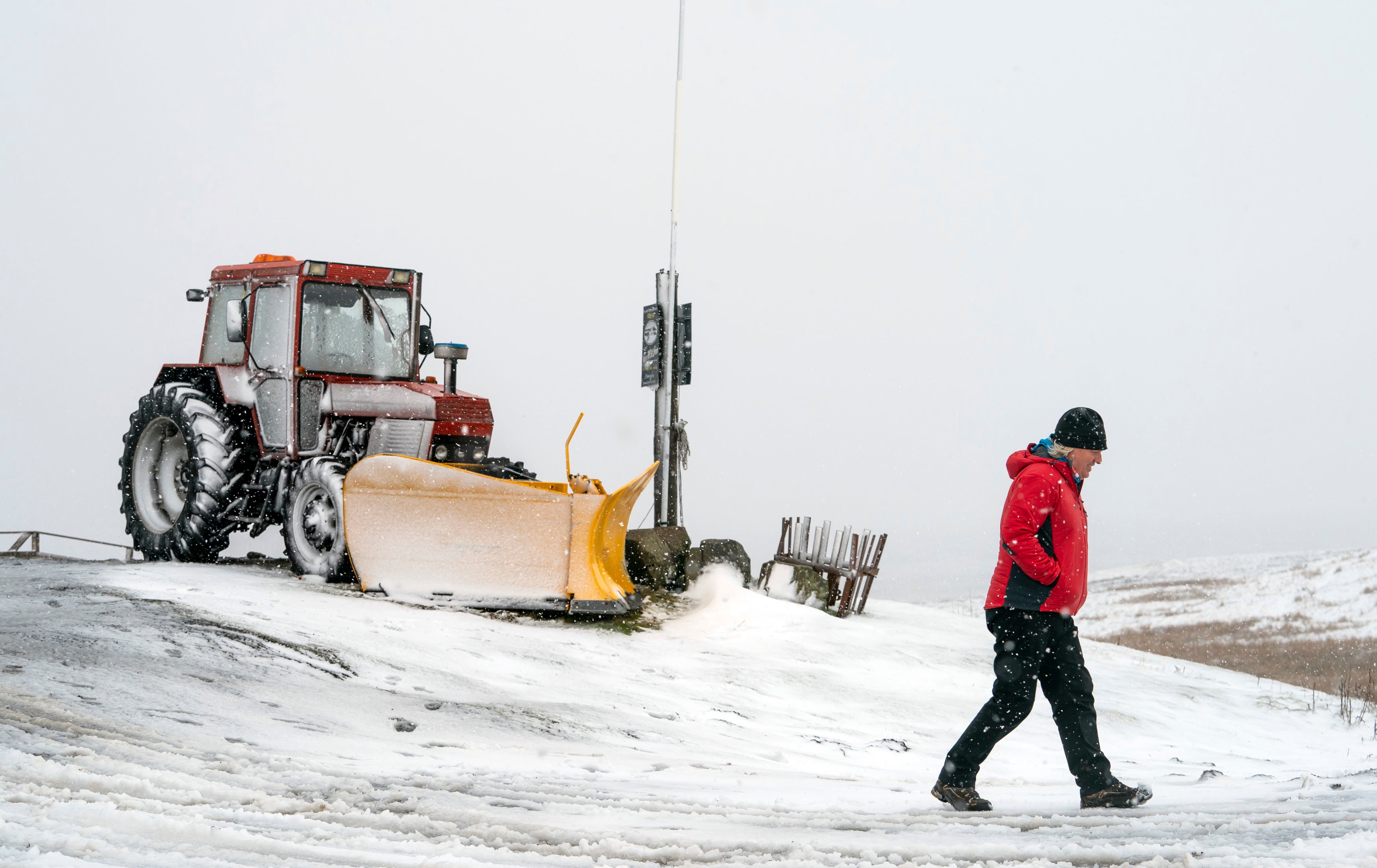 A man in snowy conditions near Tan Hill Inn, north Yorkshire