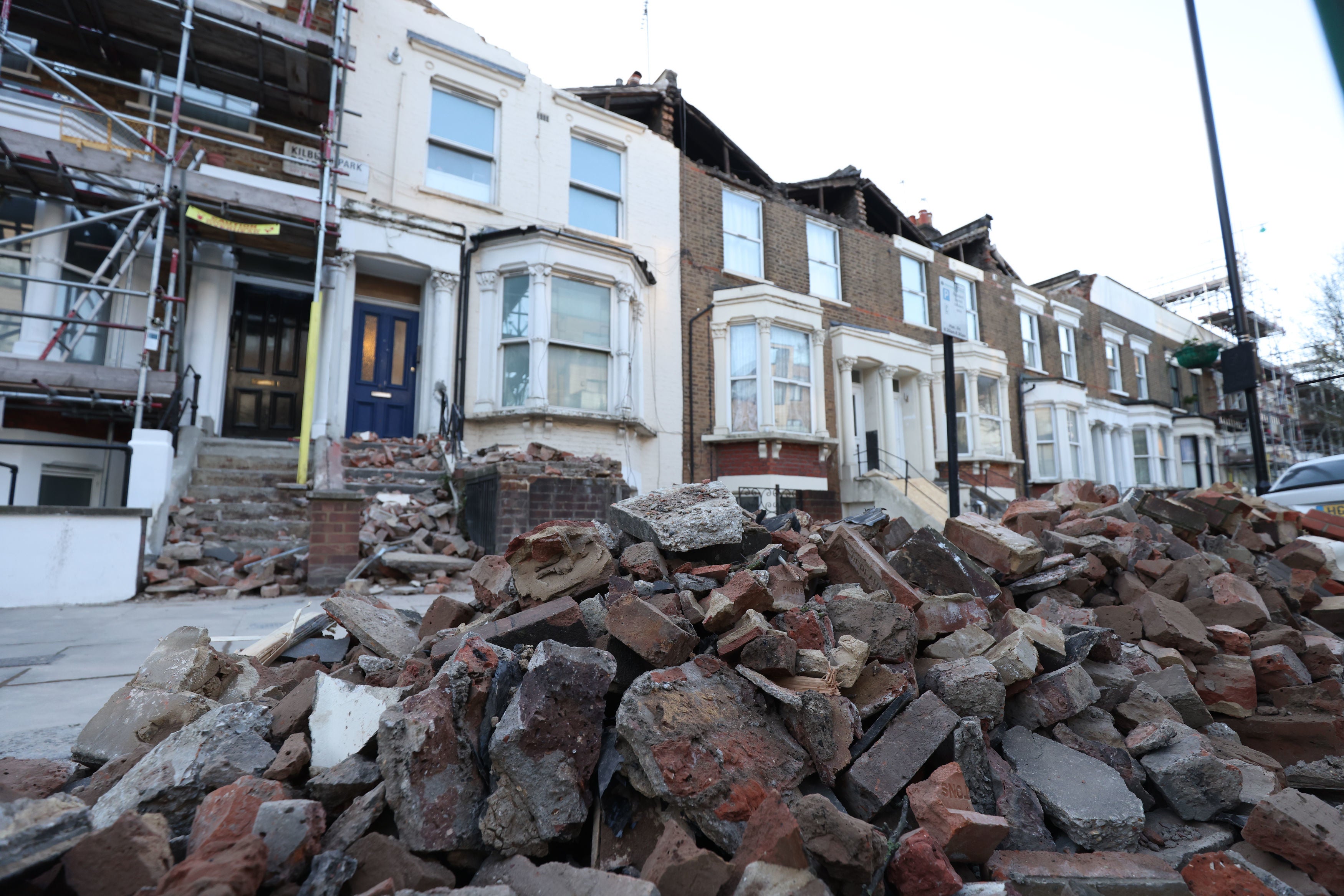 Kilburn Park Road in north west London filled with debris from the rooftops of three houses which were torn off during storm Eunice