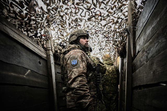 <p>Ukrainian troops patrol at the frontline outside the town of Novoluhanske, eastern Ukraine, 19 February 2022</p>
