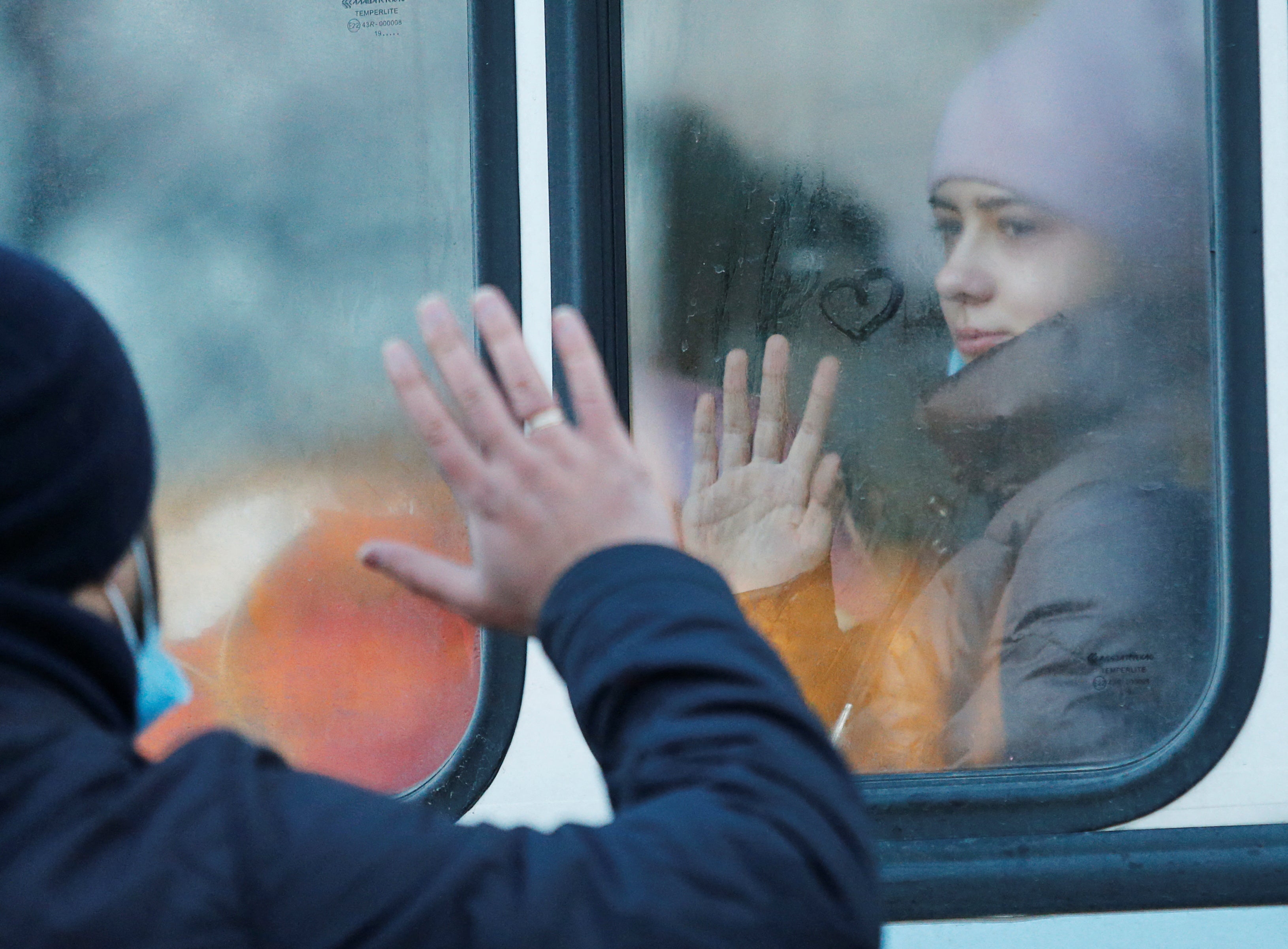A man says goodbye to his daughter during the evacuation of local residents to Russia, in the rebel-controlled city of Donetsk, Ukraine, 19 February 2022