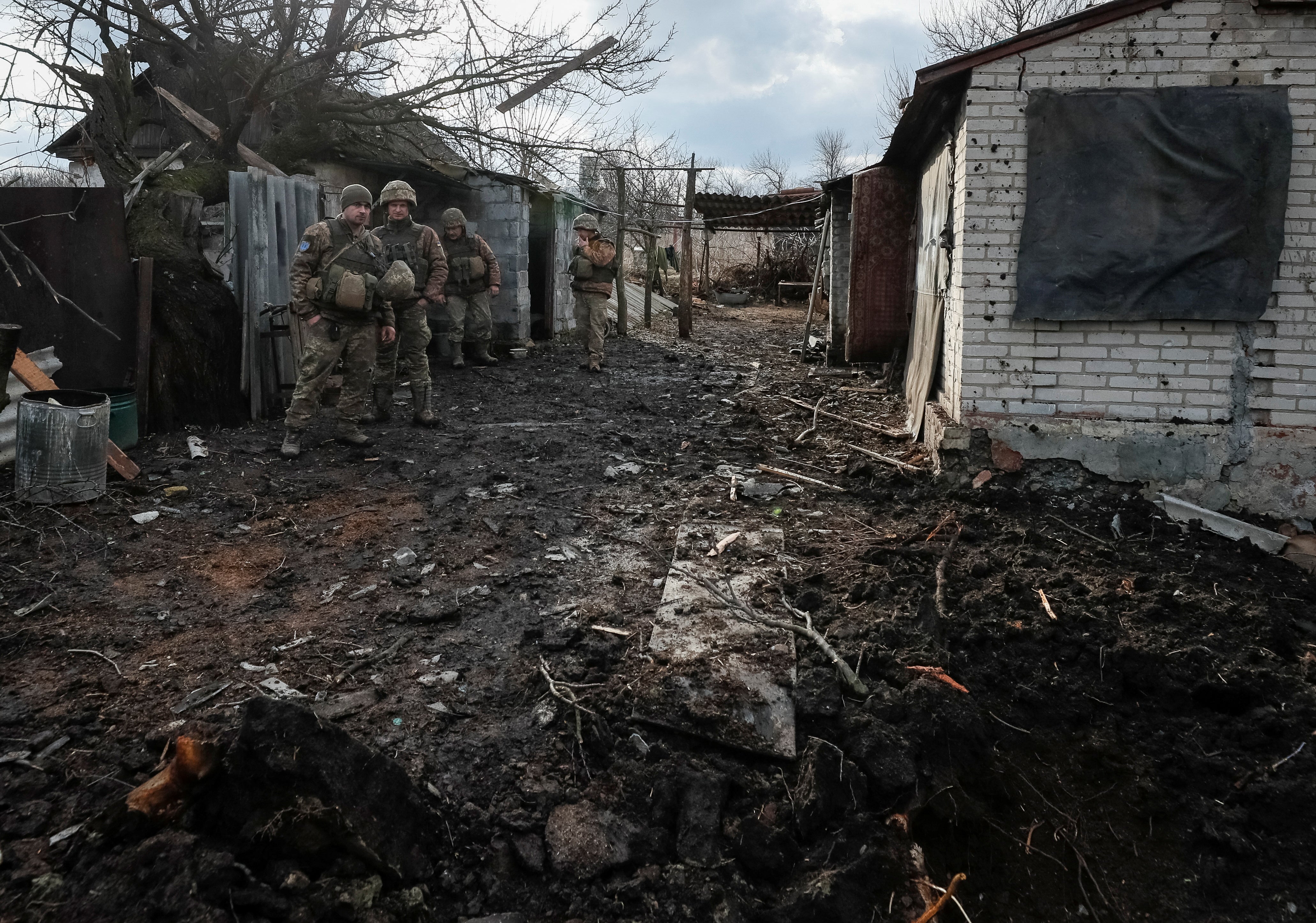 Ukrainian service members are seen on the front line after a shelling near the village of Zaitseve in the Donetsk region, Ukraine, 19 February 2022