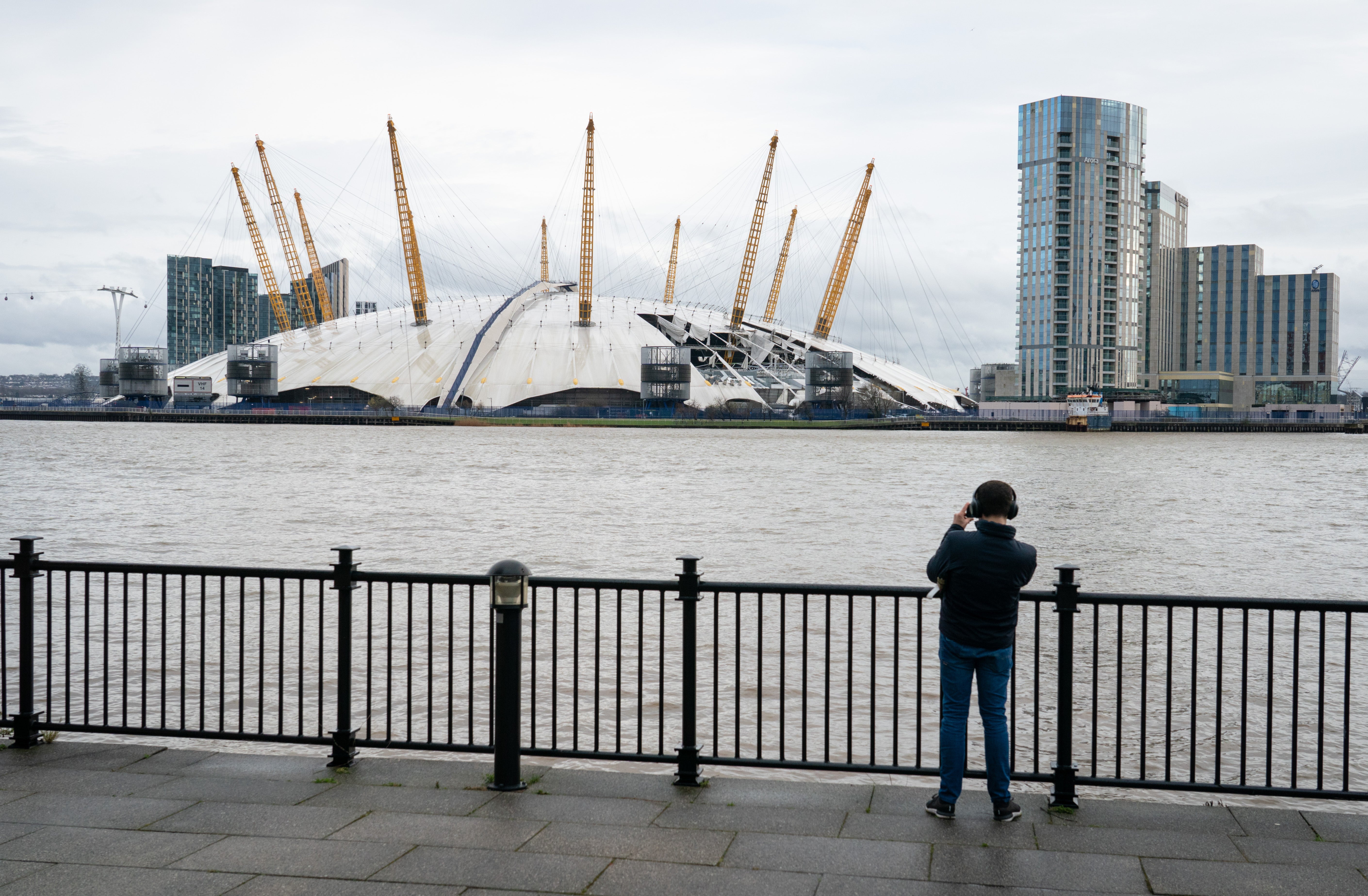 A man takes a photo of the O2 Arena in London (PA)