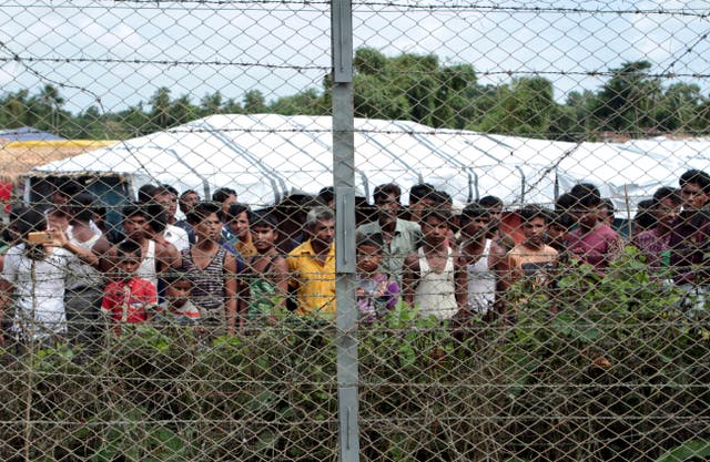 <p>File: Rohingya refugees gather near a fence during a government-organised media tour</p>