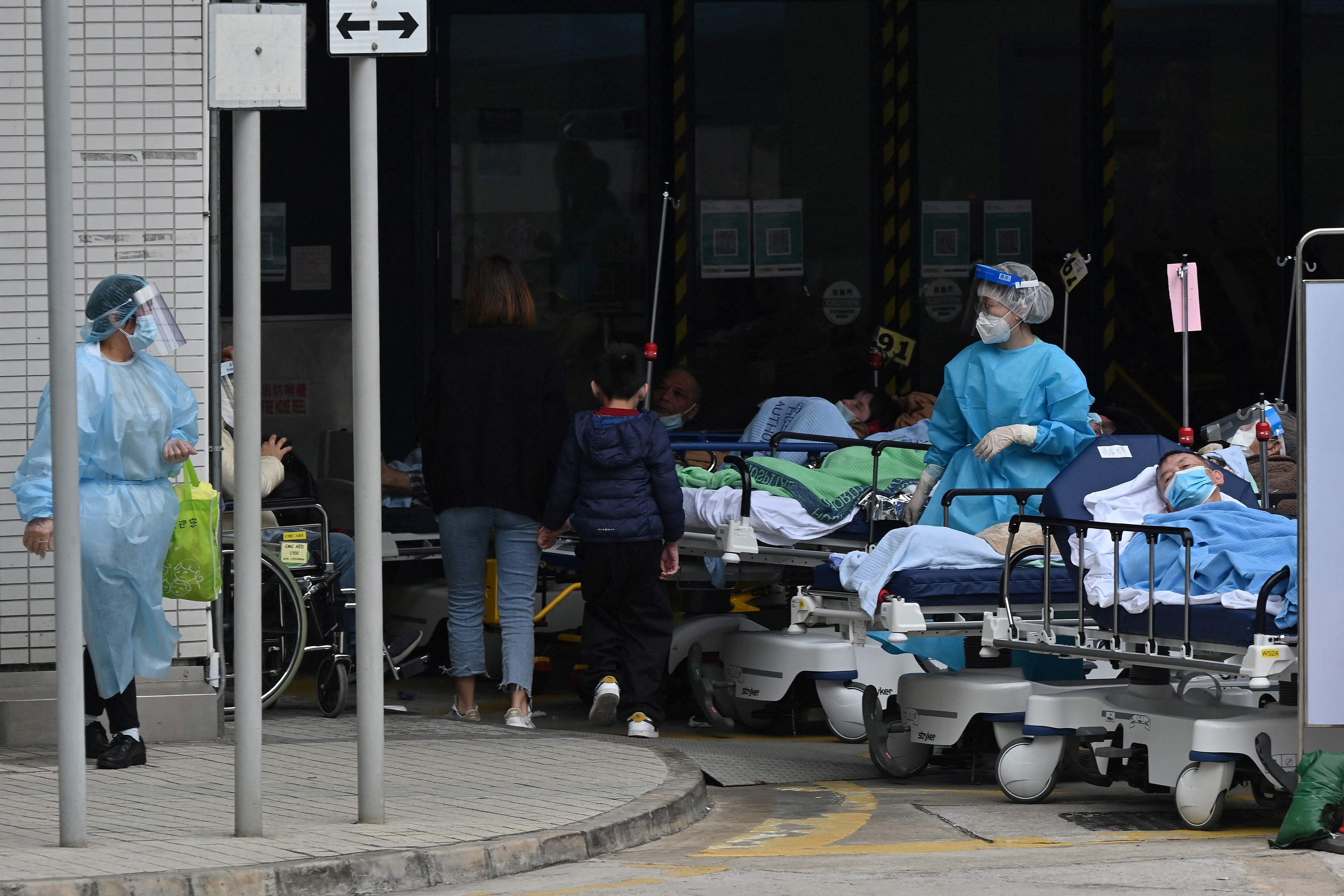 People lie in hospital beds outside the Caritas Medical Centre in Hong Kong on 18 February 2022