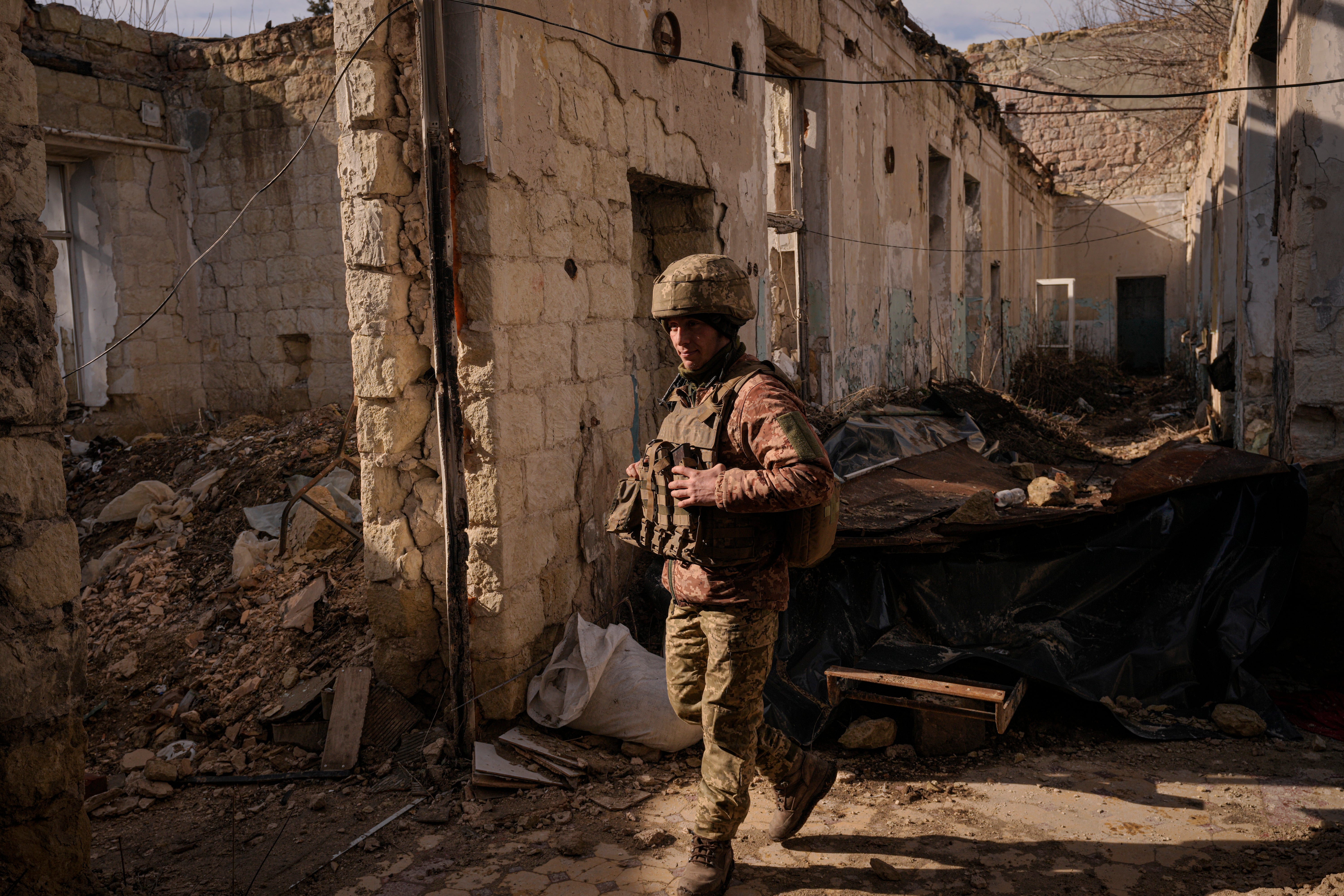 A Ukrainian serviceman walks inside a destroyed house near the frontline village of Krymske, Luhansk region, in eastern Ukraine (Vadim Ghirda/PA)