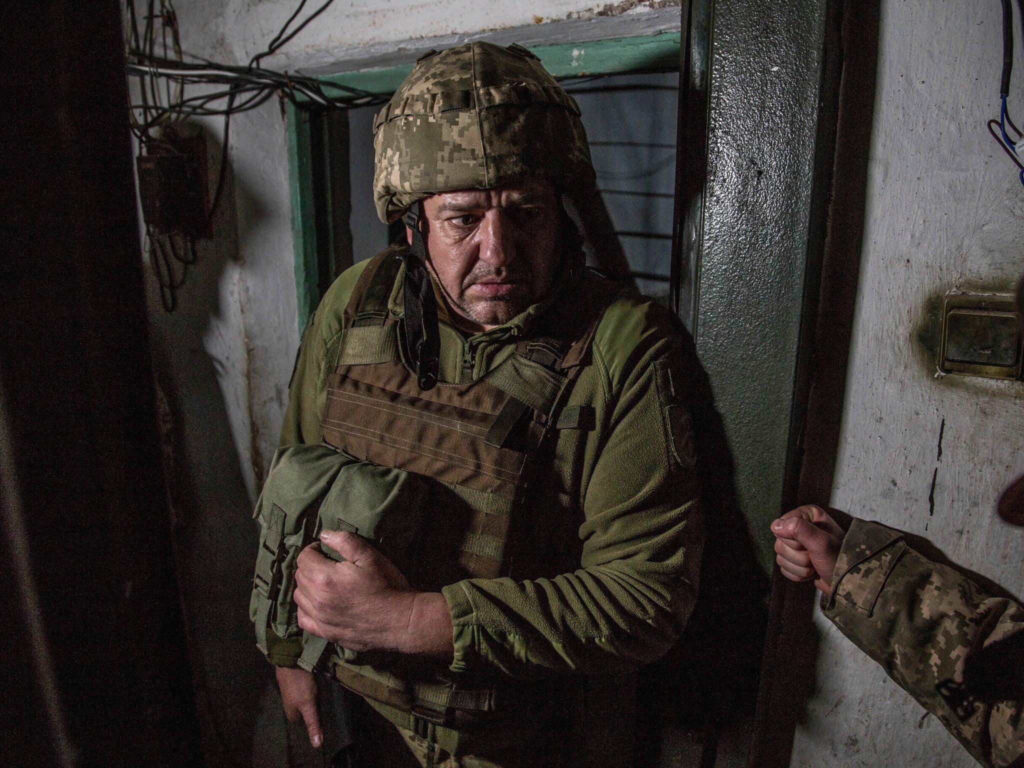 Ukrainian soldiers hide in a shelter during shelling in the village of Novoluhanske