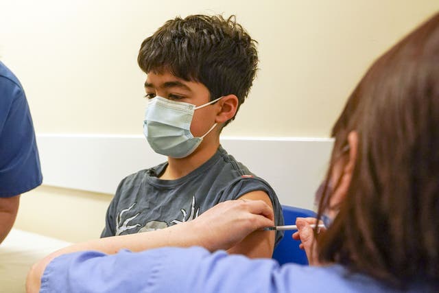 Xavier Aquilina, aged 11, has a Covid-19 vaccination at the Emberbrook Community Centre for Health in Thames Ditton, Surrey (Steve Parsons/PA)