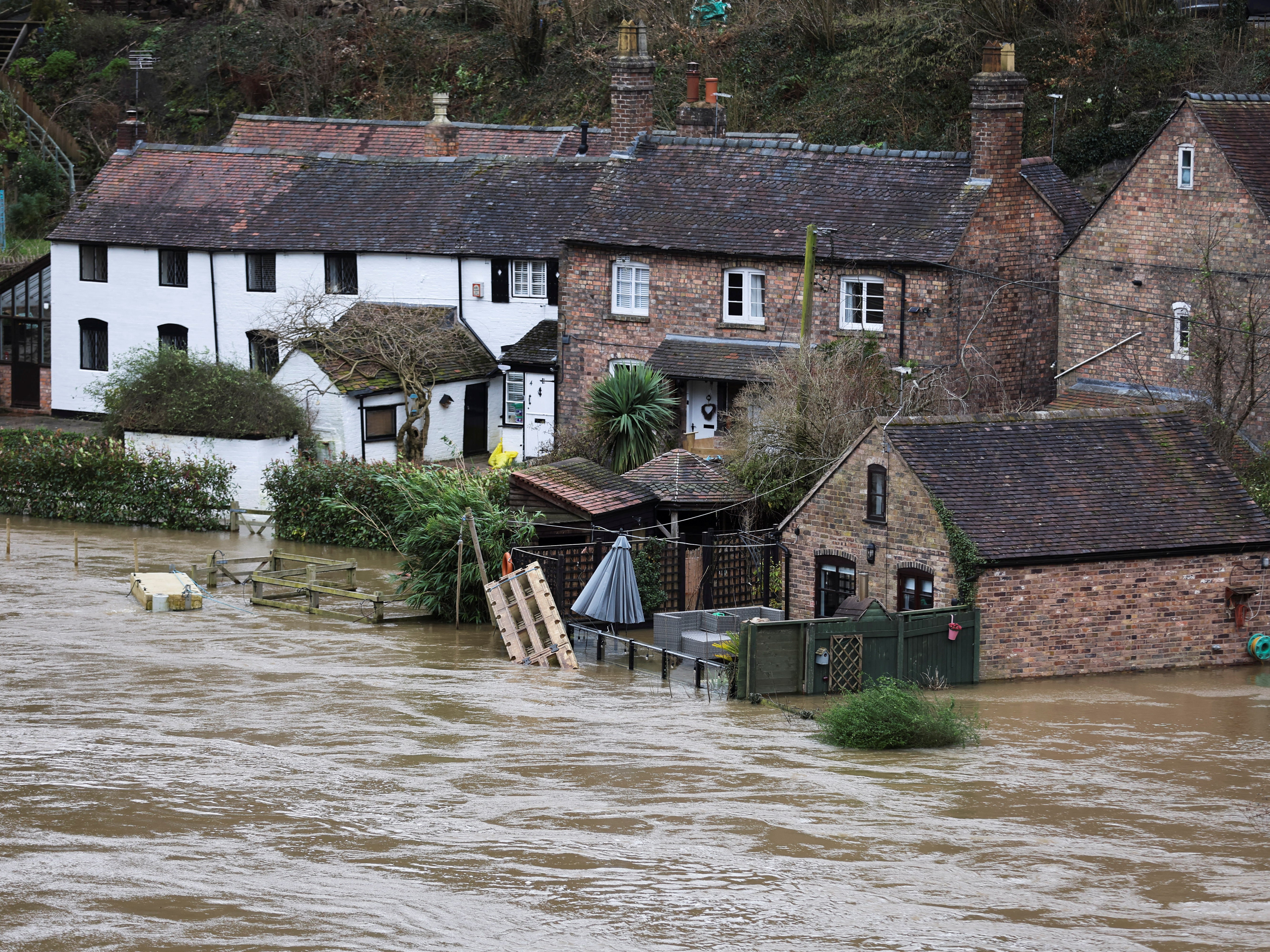 Houses are flooded after high water levels on the River Severn in Ironbridge during Storm Franklin