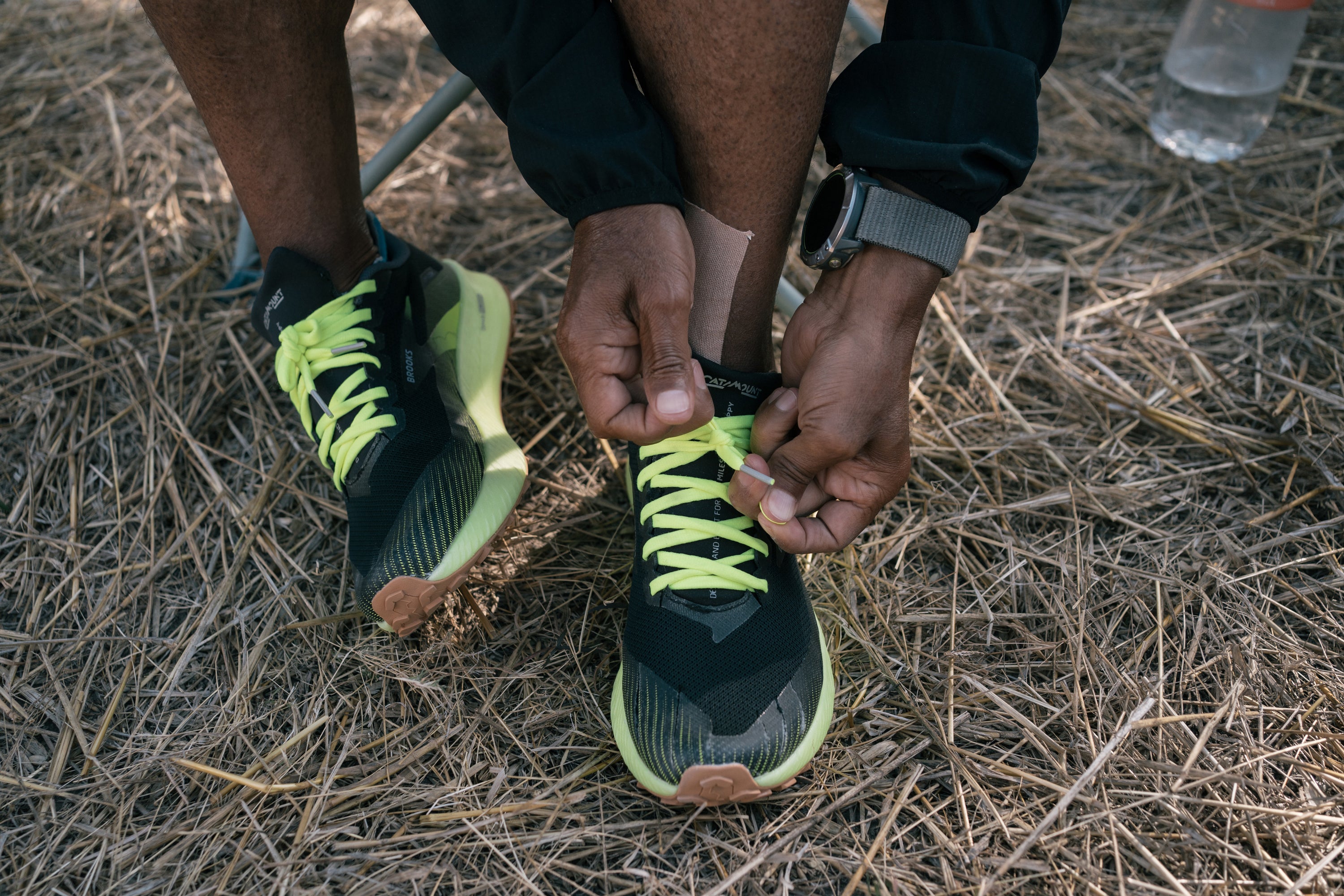 The retired long distance runner ties his shoe laces during a meal break