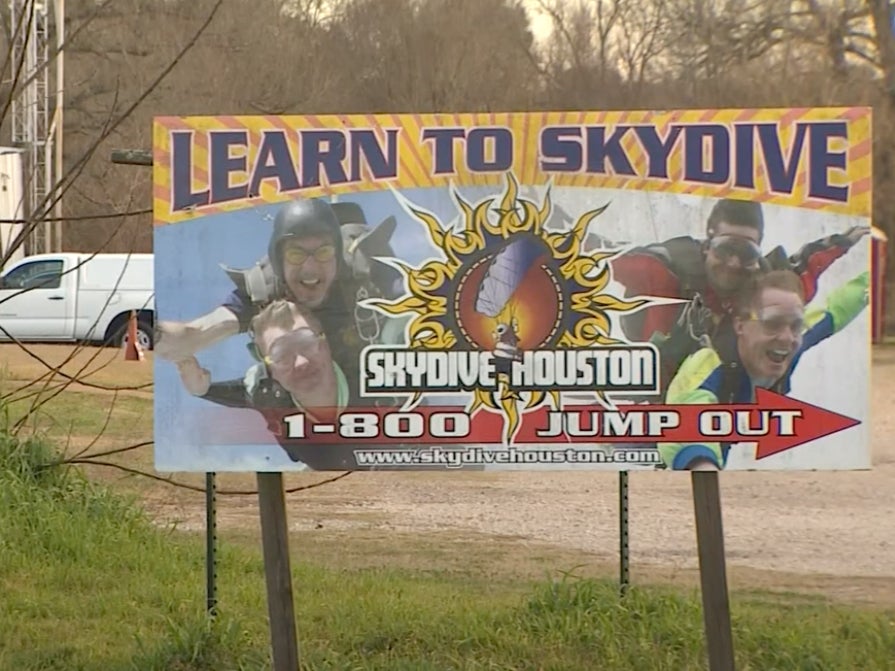 A billboard for “Skydive Houston,” which offers tandem skydiving lessons. One of the instructors at the school died during a tandem jump in February after an accident involving his parachute malfunctioned.