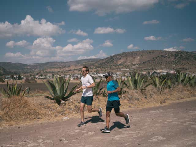 <p>Kevin Sieff (left) and Germán Silva run along a dirt road in Tlaxcala</p>