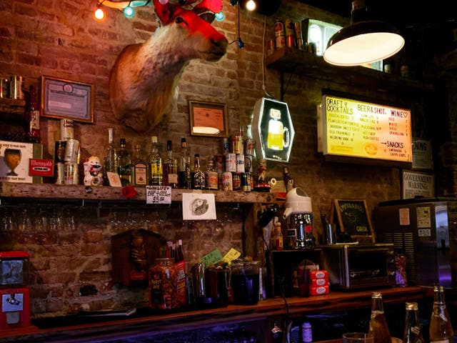 <p>Near and deer: the bar, complete with toy stag’s head</p>