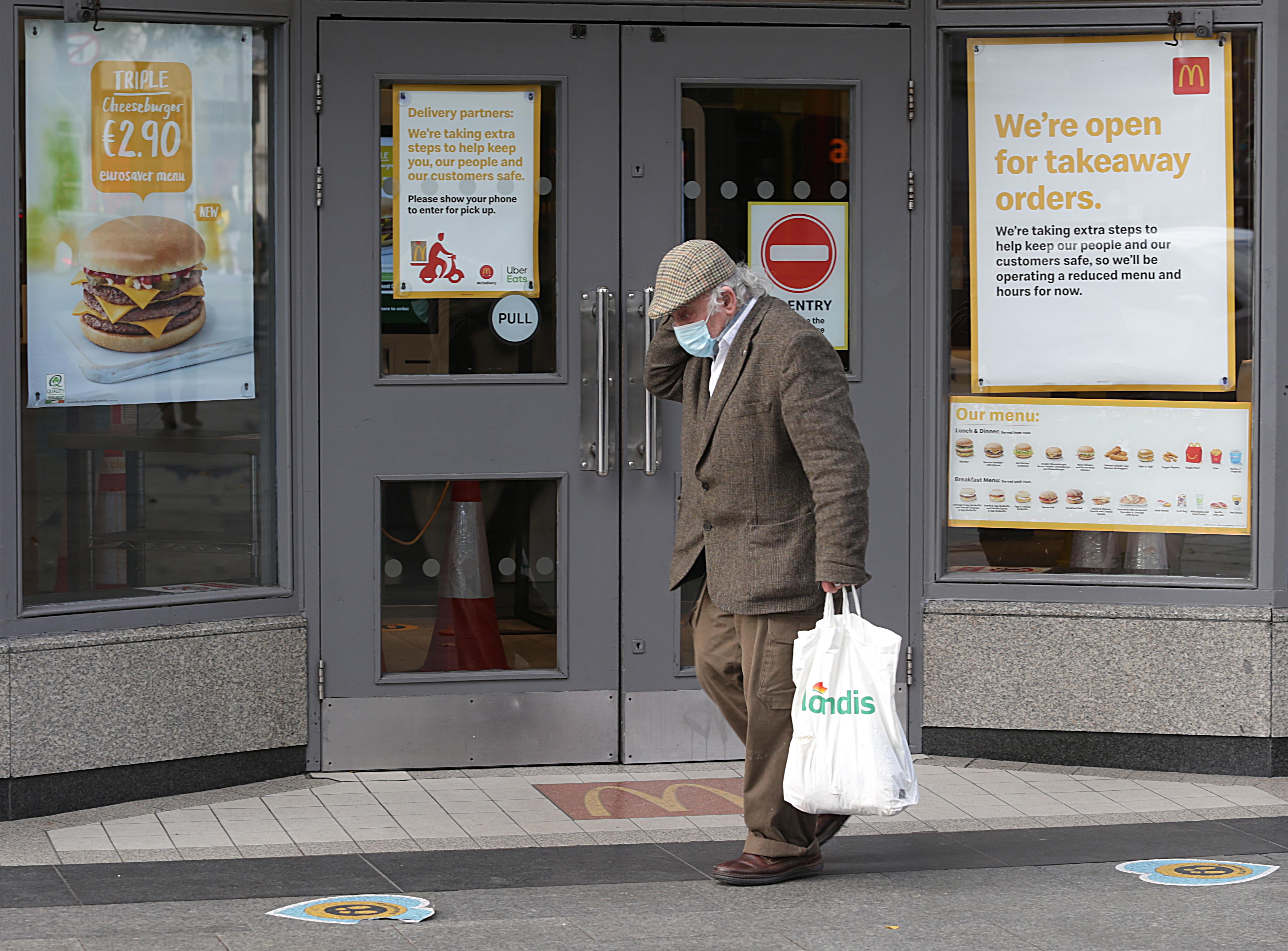 A man wearing a face mask walks along O’Connell Street, Dublin (Damien Eagers/PA)
