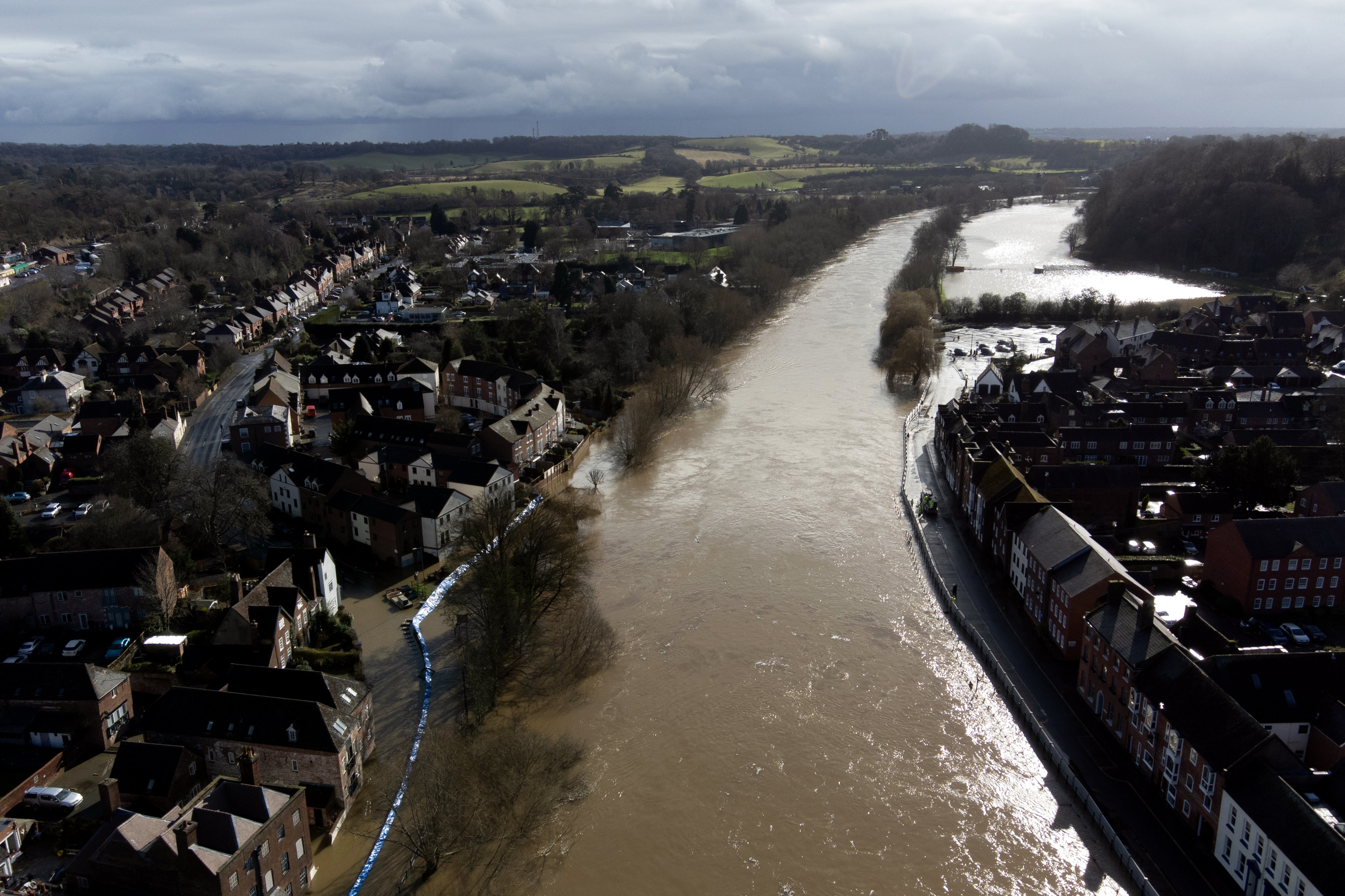 Water begins to spill behind flood defences along the River Severn at Bewdley in Worcestershire