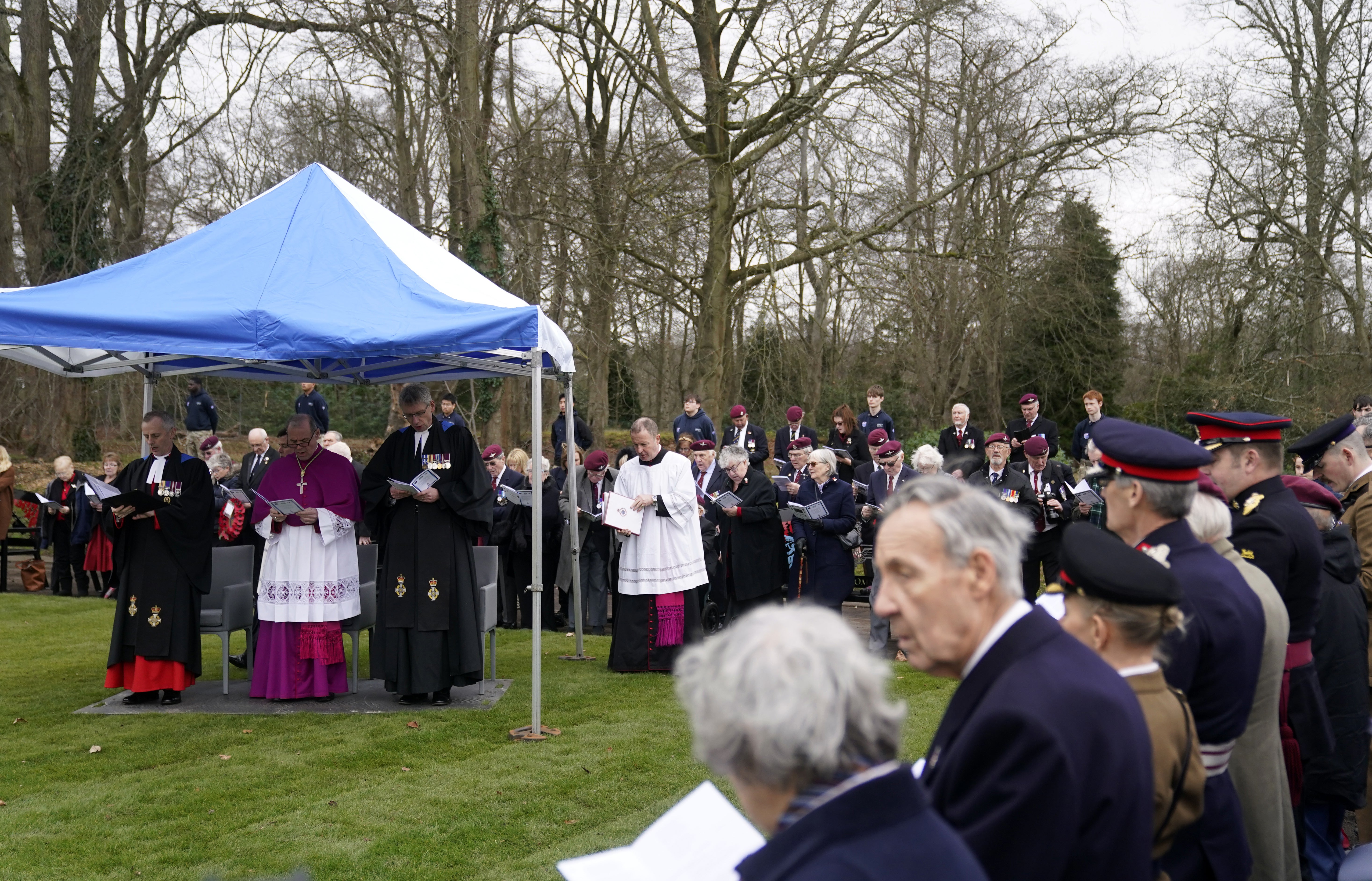 Veterans and family members take part in the dedication service (Andrew Matthews/PA)