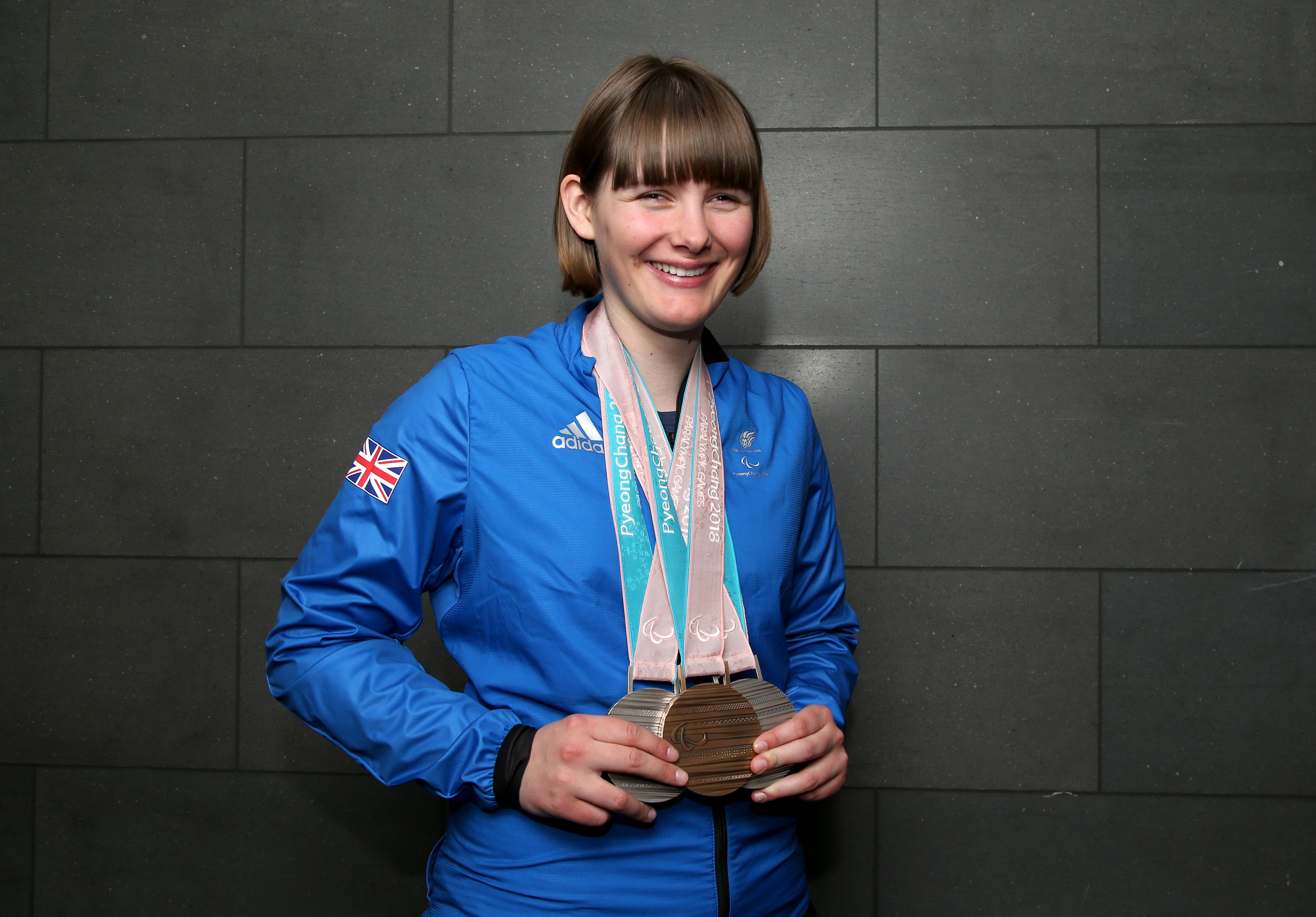 Millie Knight poses with her medals after arriving back from the PyeongChang 2018 Paralympic Winter Games