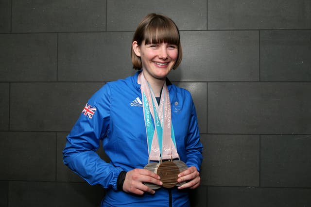 <p>Millie Knight poses with her medals after arriving back from the PyeongChang 2018 Paralympic Winter Games</p>